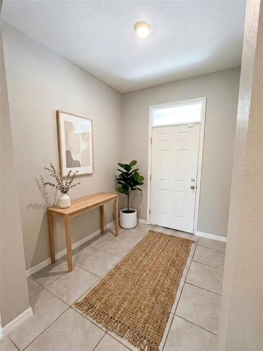 Inside entryway virtually staged - 5254 DRAGONFLY DR, WILDWOOD