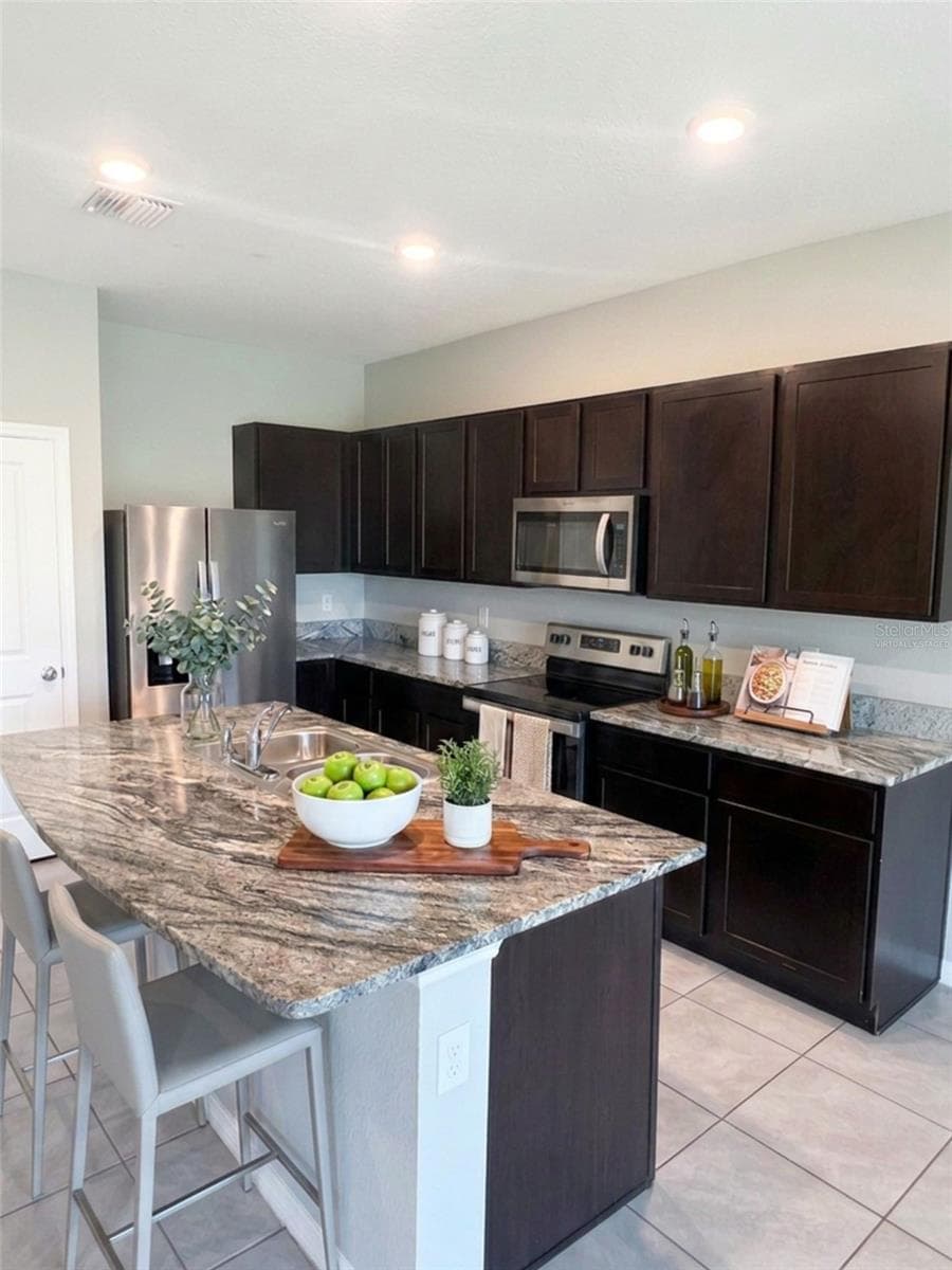 Kitchen view virtually staged - 5254 DRAGONFLY DR, WILDWOOD