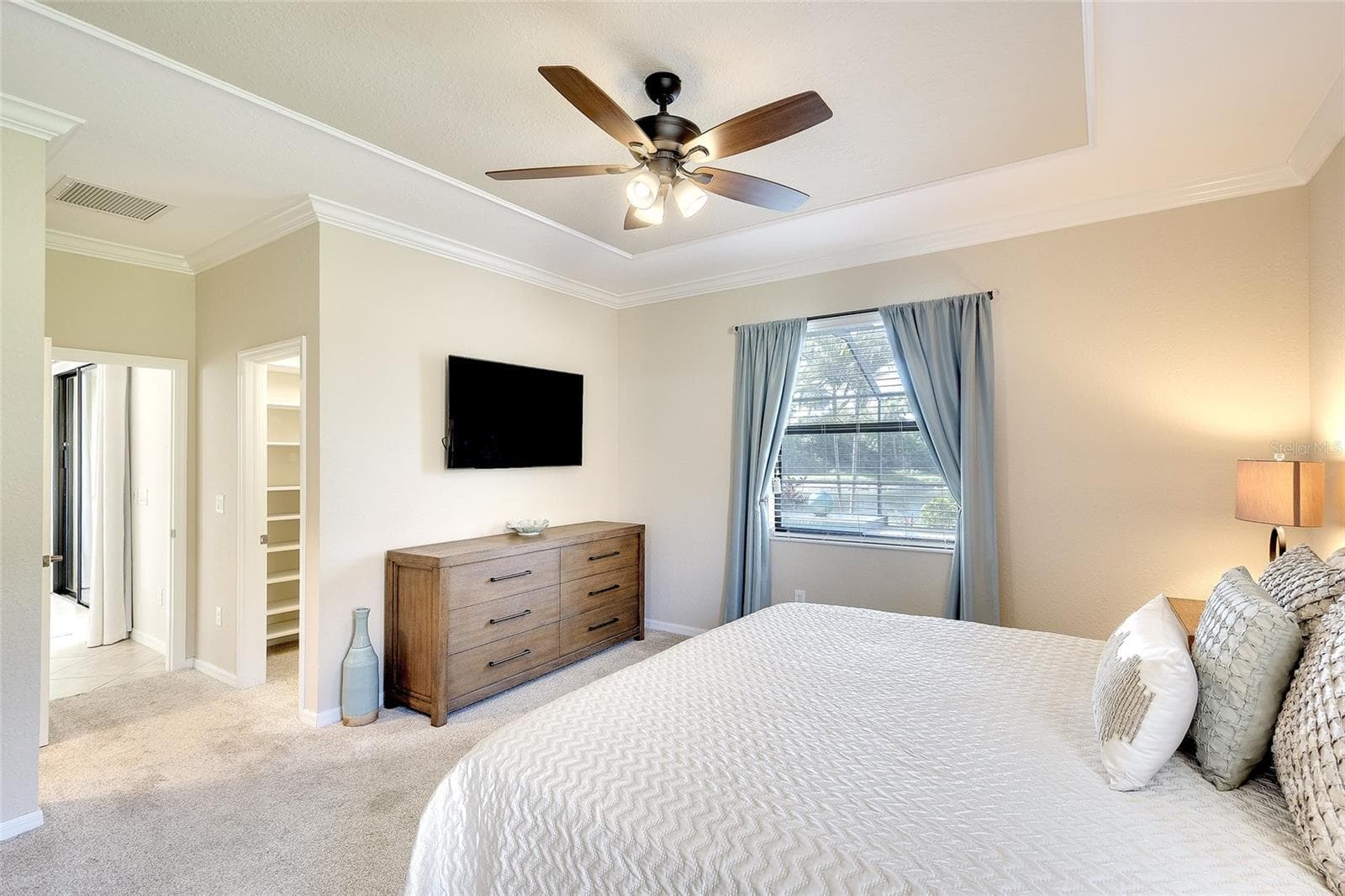Peaceful Primary Bedroom with Tray Ceiling Detail - 7130 QUIET CREEK DR, BRADENTON