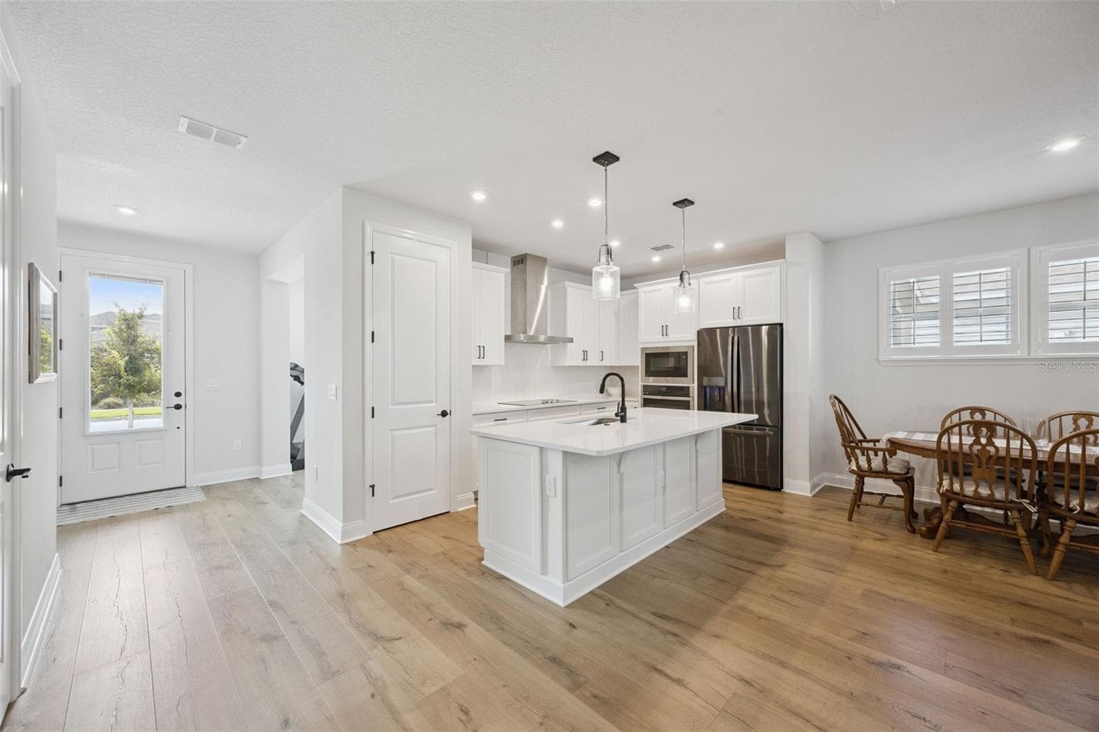 Rustic Mohawk Laminate Wood Plank Flooring throughout the lower level and stairway. - 2954 JOURNEY PL, ST CLOUD