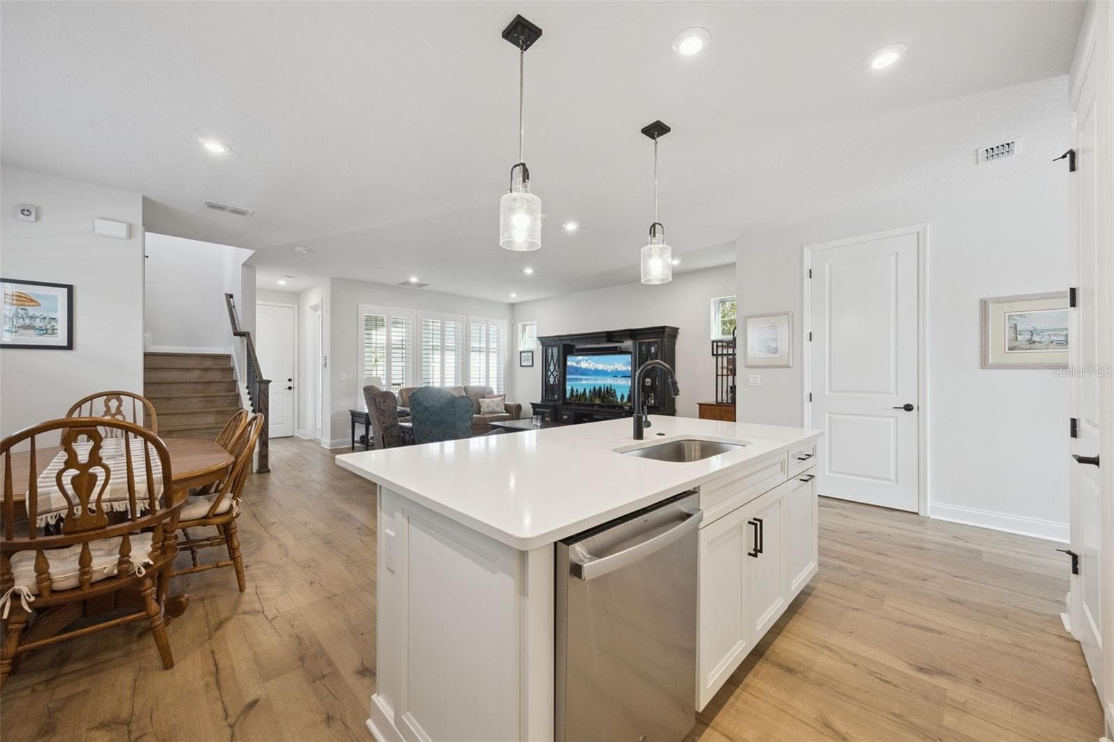 Kitchen Island features a Single Bowl Stainless Sink (a must!) highlighted by a Matte Black Moen Faucet and Coordinating Pendant Lighting. - 2954 JOURNEY PL, ST CLOUD