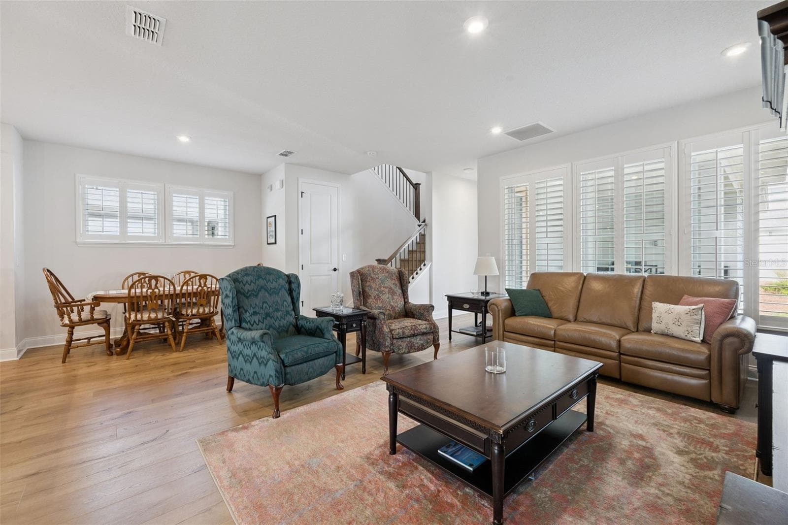 Informal Dining Space open to the Family Room. Plantations shutters throughtout this home add tremendous style and light. - 2954 JOURNEY PL, ST CLOUD