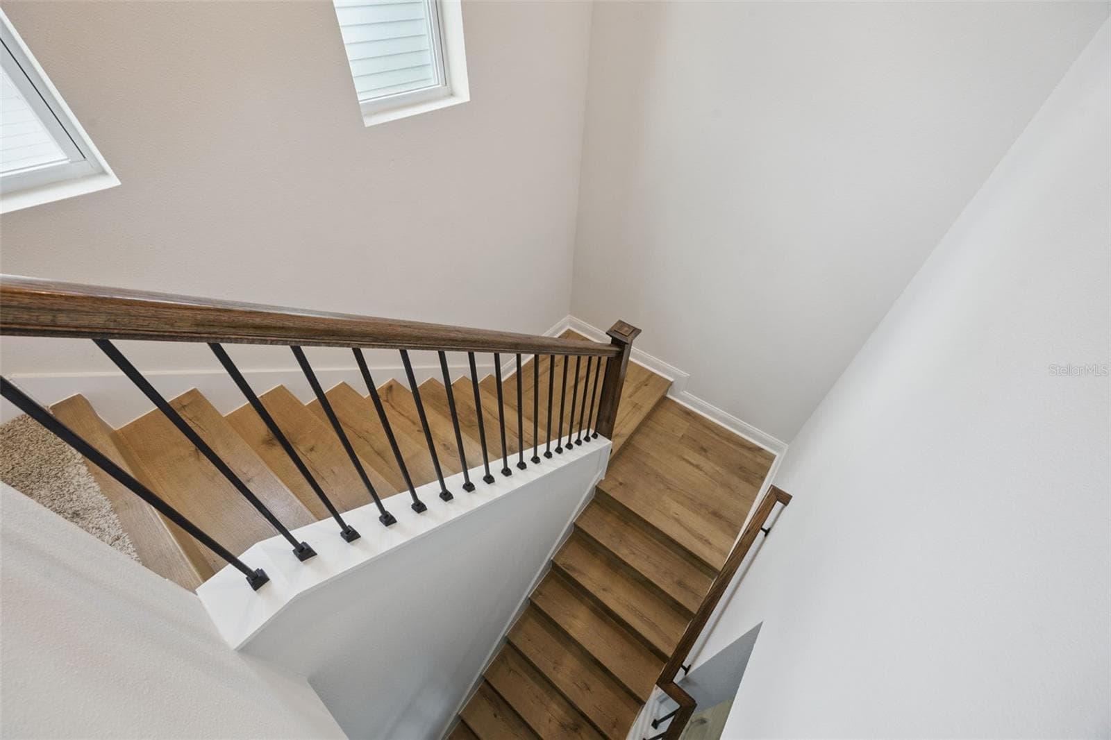 The laminate wood plank staircase with architectural landings make a comforable transition to the spacious 2nd level. - 2954 JOURNEY PL, ST CLOUD
