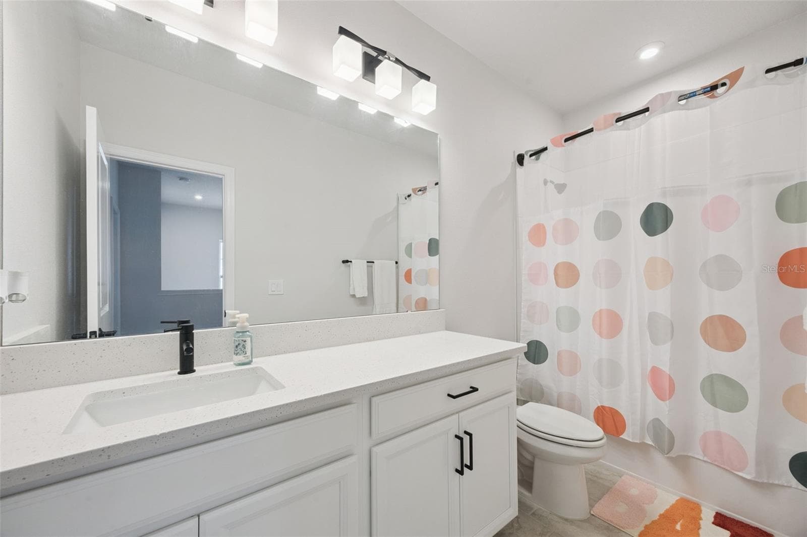 Secondary Bathroom with a Generous Vanity and Designer Black Matt Fixtures. - 2954 JOURNEY PL, ST CLOUD