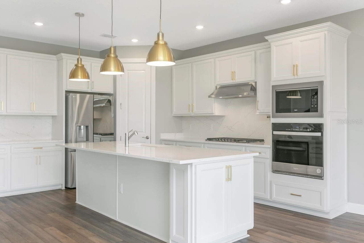 Luxury Kitchen with Large island, built in oven, closet pantry, custom fixtures, solid backsplash - 9909 LONGMEADOW AVE, PARRISH