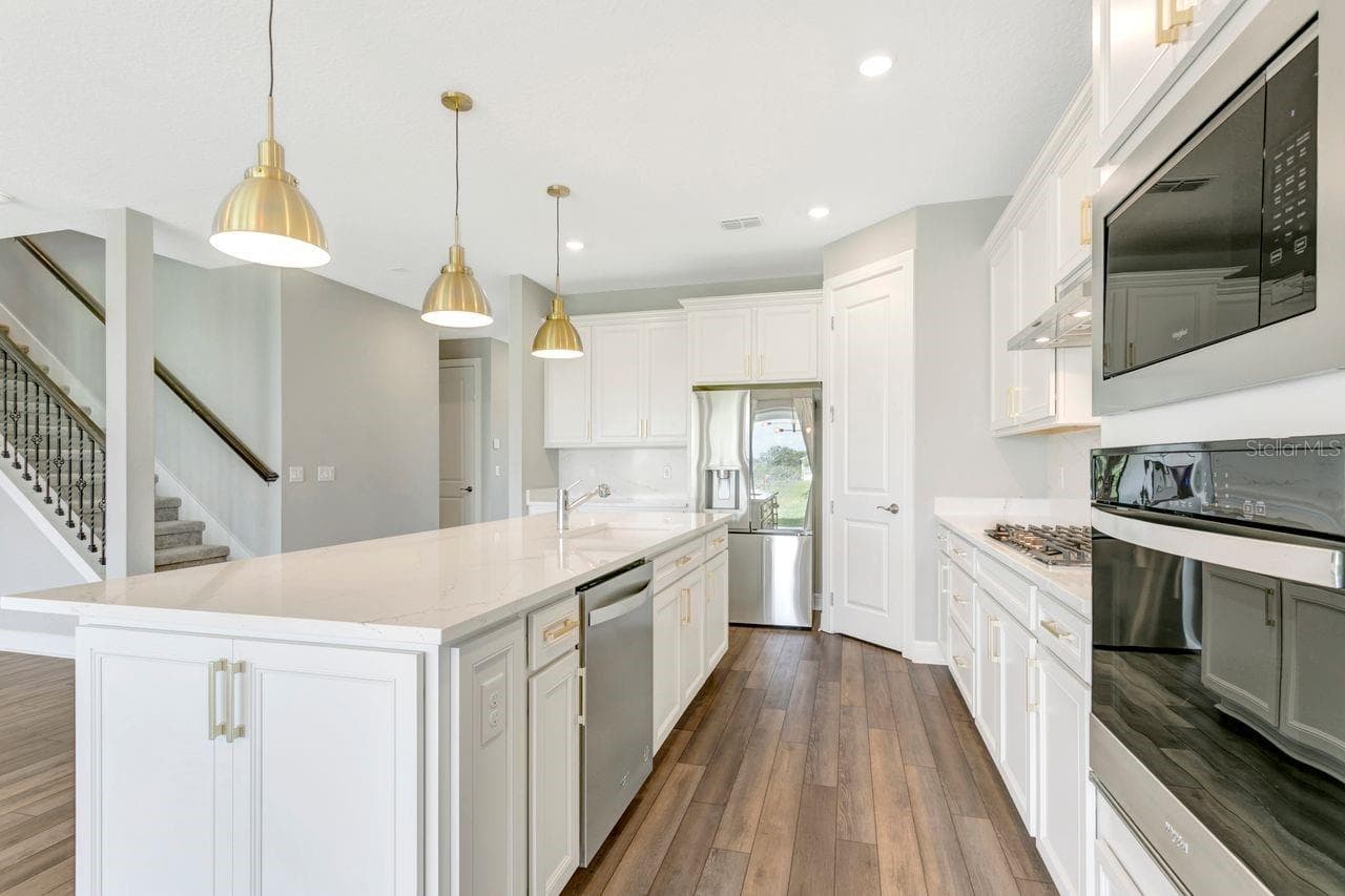 Luxury Kitchen with Large island, built in oven, closet pantry, custom fixtures, solid backsplash - 9909 LONGMEADOW AVE, PARRISH
