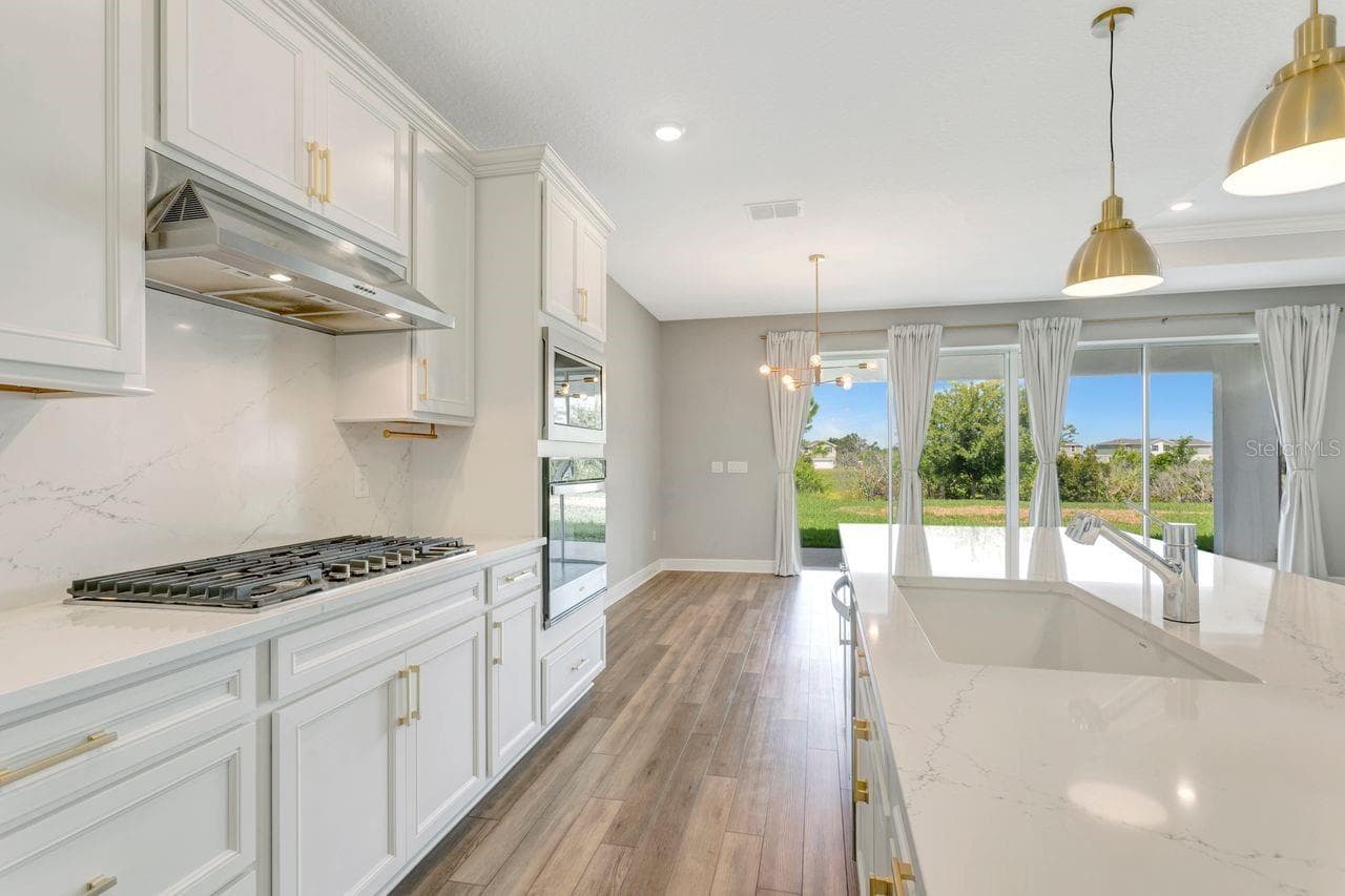 Luxury Kitchen with Large island, built in oven, closet pantry, custom fixtures, solid backsplash - 9909 LONGMEADOW AVE, PARRISH