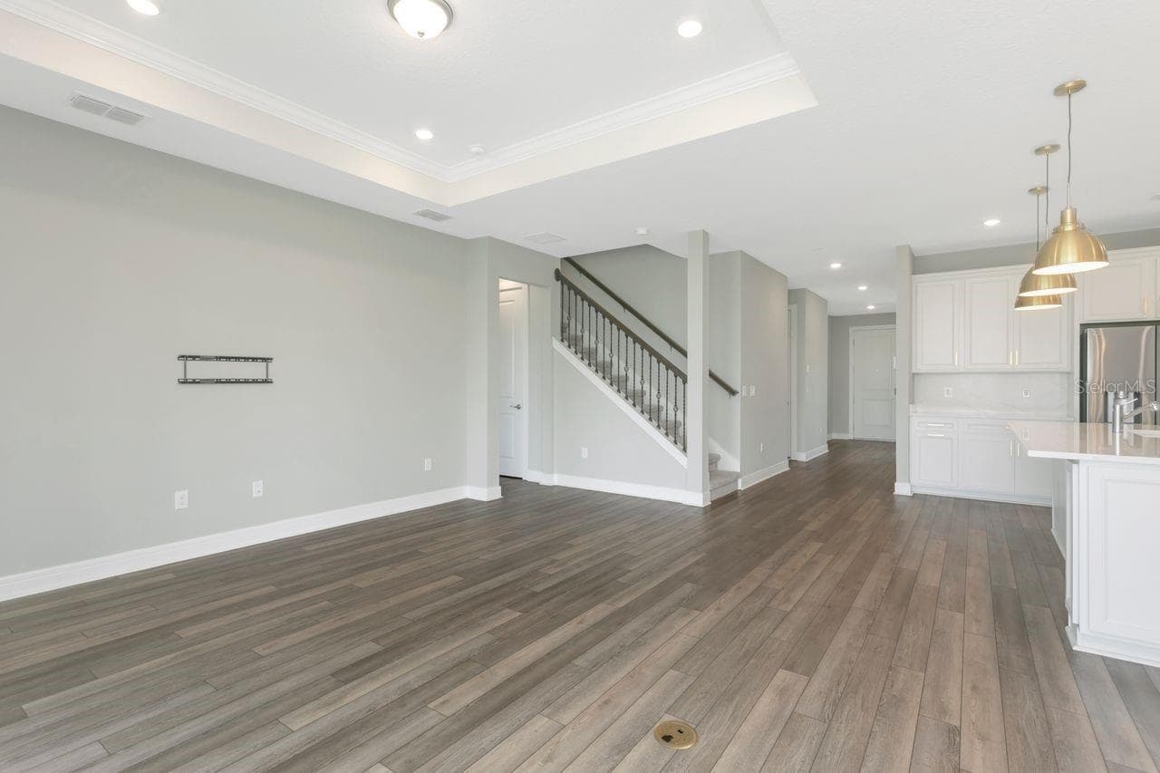 Open Living space with tray ceilings and recessed lighting - 9909 LONGMEADOW AVE, PARRISH