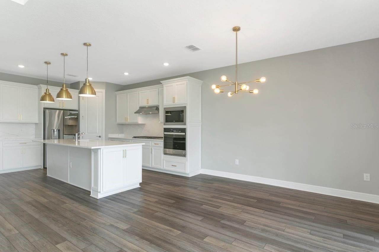 Luxury Kitchen with Large island, built in oven, closet pantry, custom fixtures, solid backsplash - 9909 LONGMEADOW AVE, PARRISH