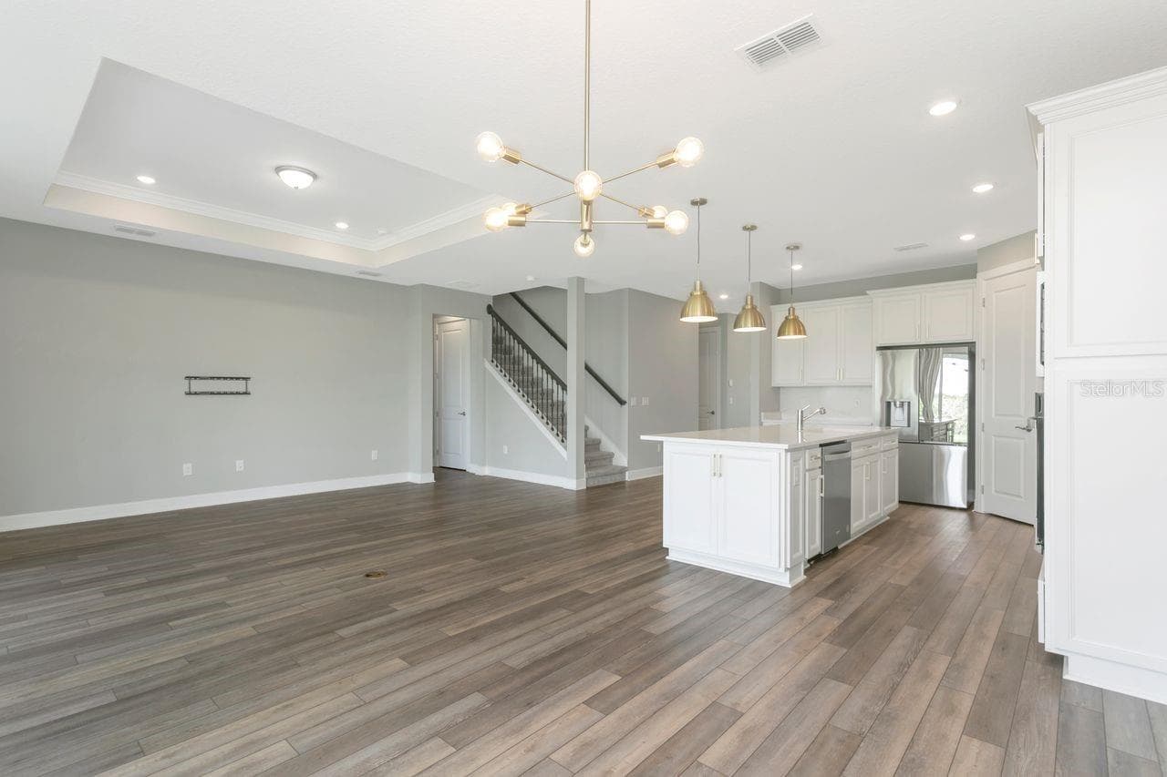 Open Living space with tray ceilings and recessed lighting - 9909 LONGMEADOW AVE, PARRISH