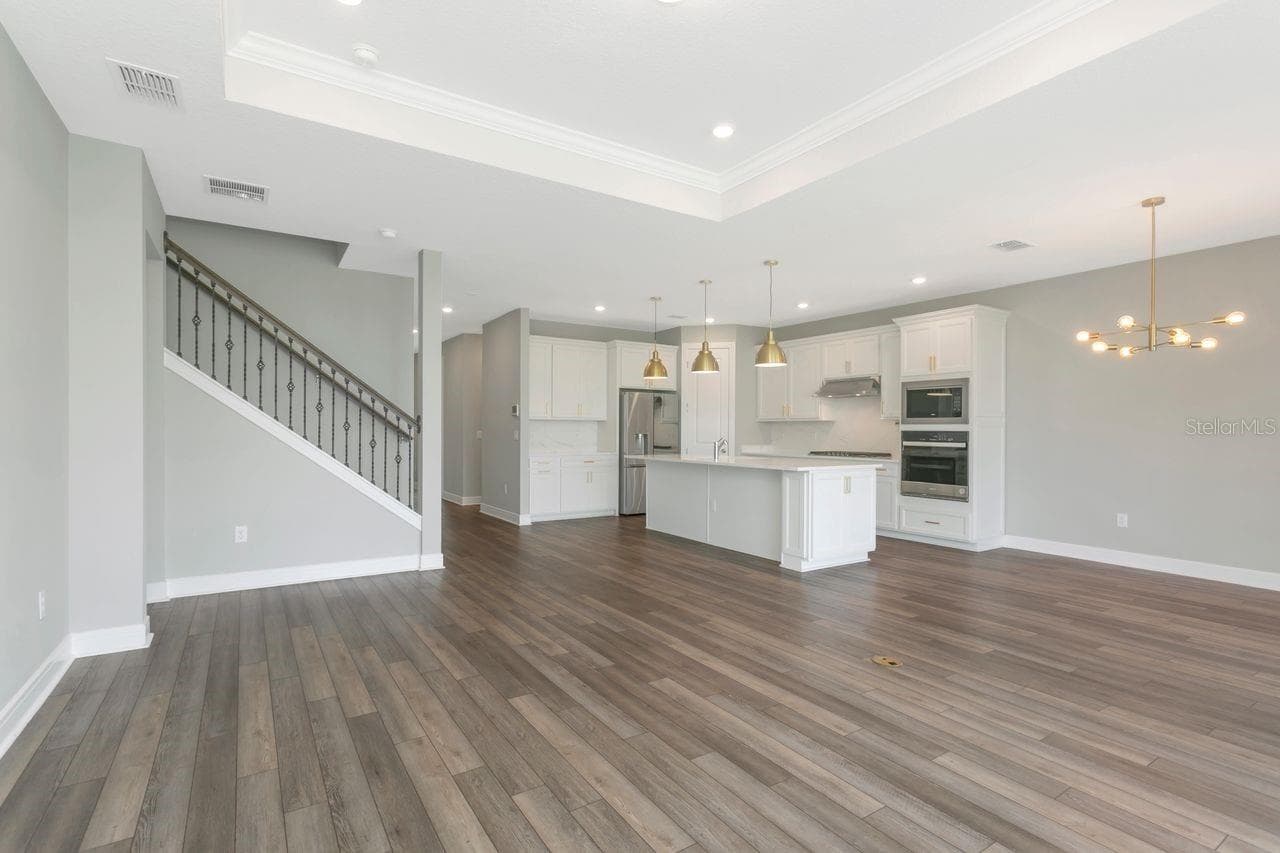 Open Living space with tray ceilings and recessed lighting - 9909 LONGMEADOW AVE, PARRISH
