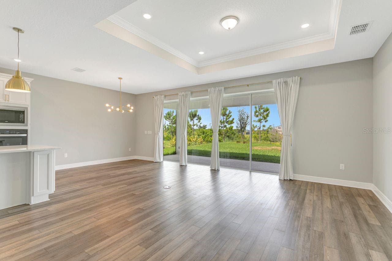 Open Living space with tray ceilings and recessed lighting - 9909 LONGMEADOW AVE, PARRISH