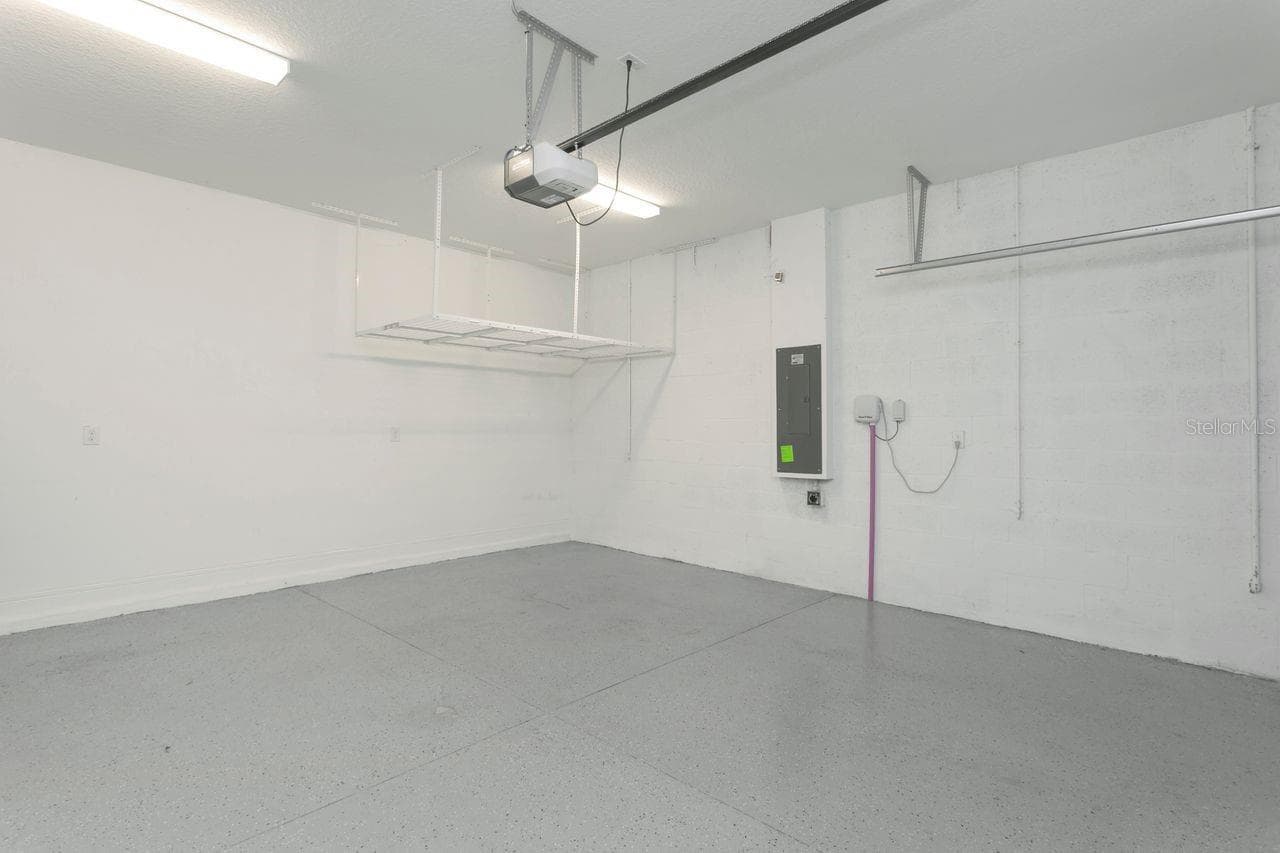 2 Car Garage with epoxy flooring and overhead rack - 9909 LONGMEADOW AVE, PARRISH