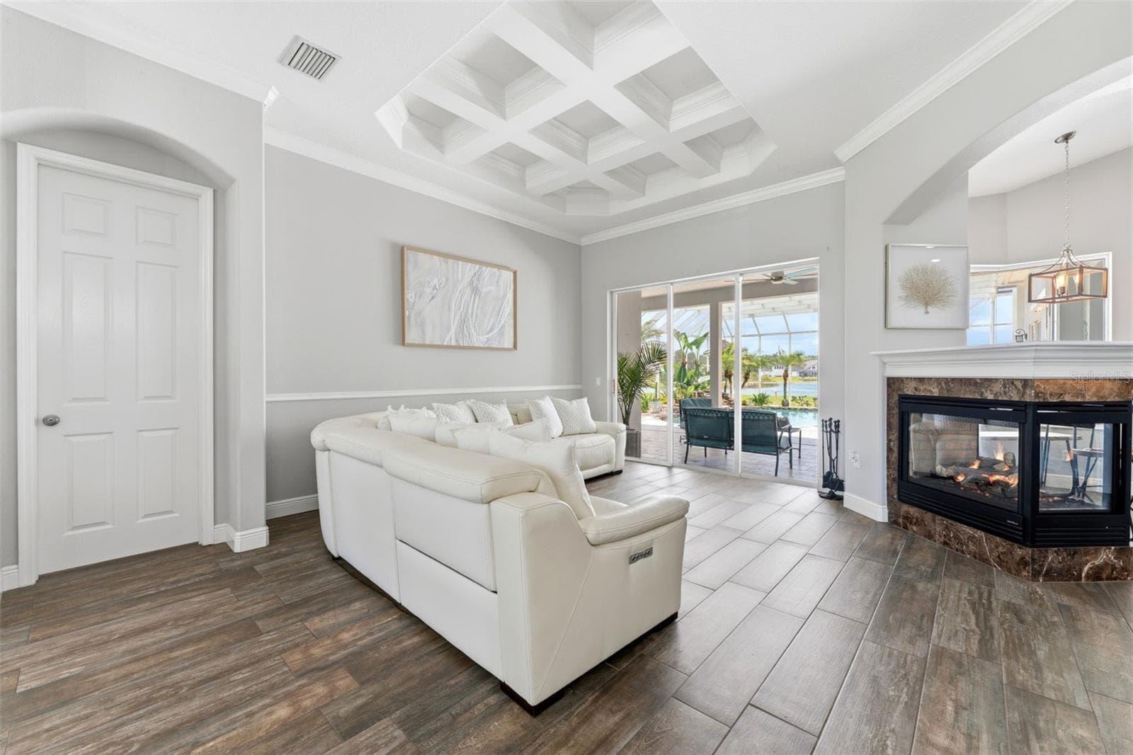 Formal Living Room With Fireplace, Pool and Lake Views - 24355 HIDEOUT TRL, LAND O LAKES
