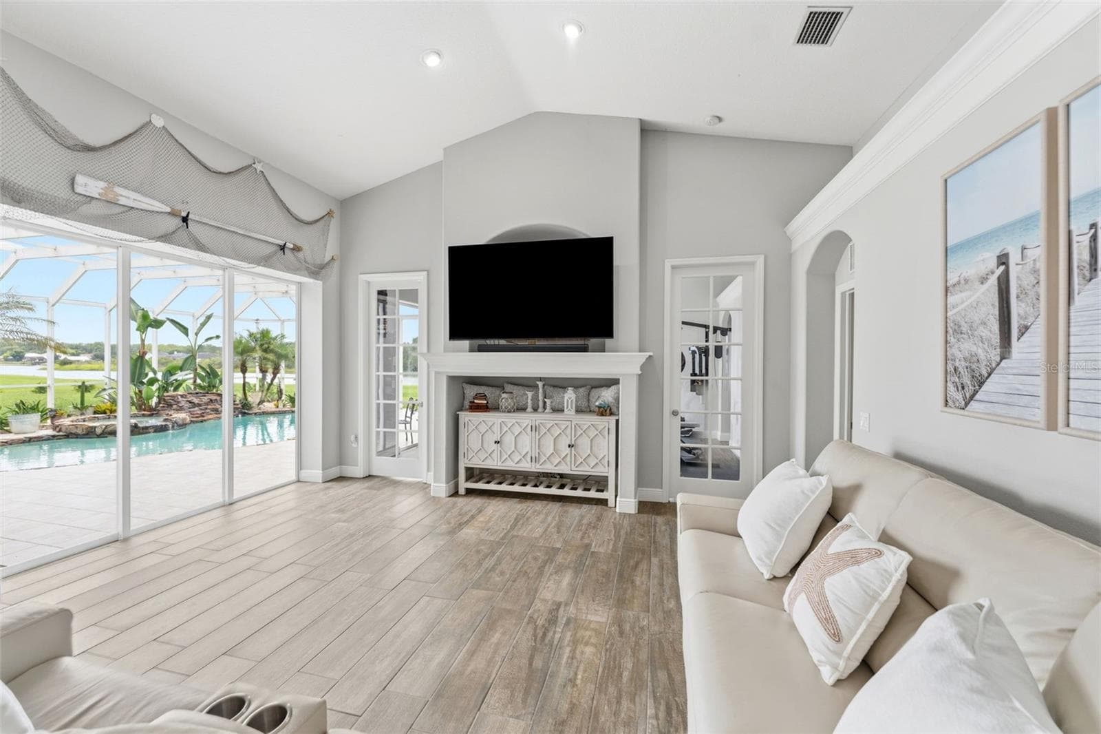Spacious Family Room Featuring Breathtaking Views of the Pool and Lake - 24355 HIDEOUT TRL, LAND O LAKES