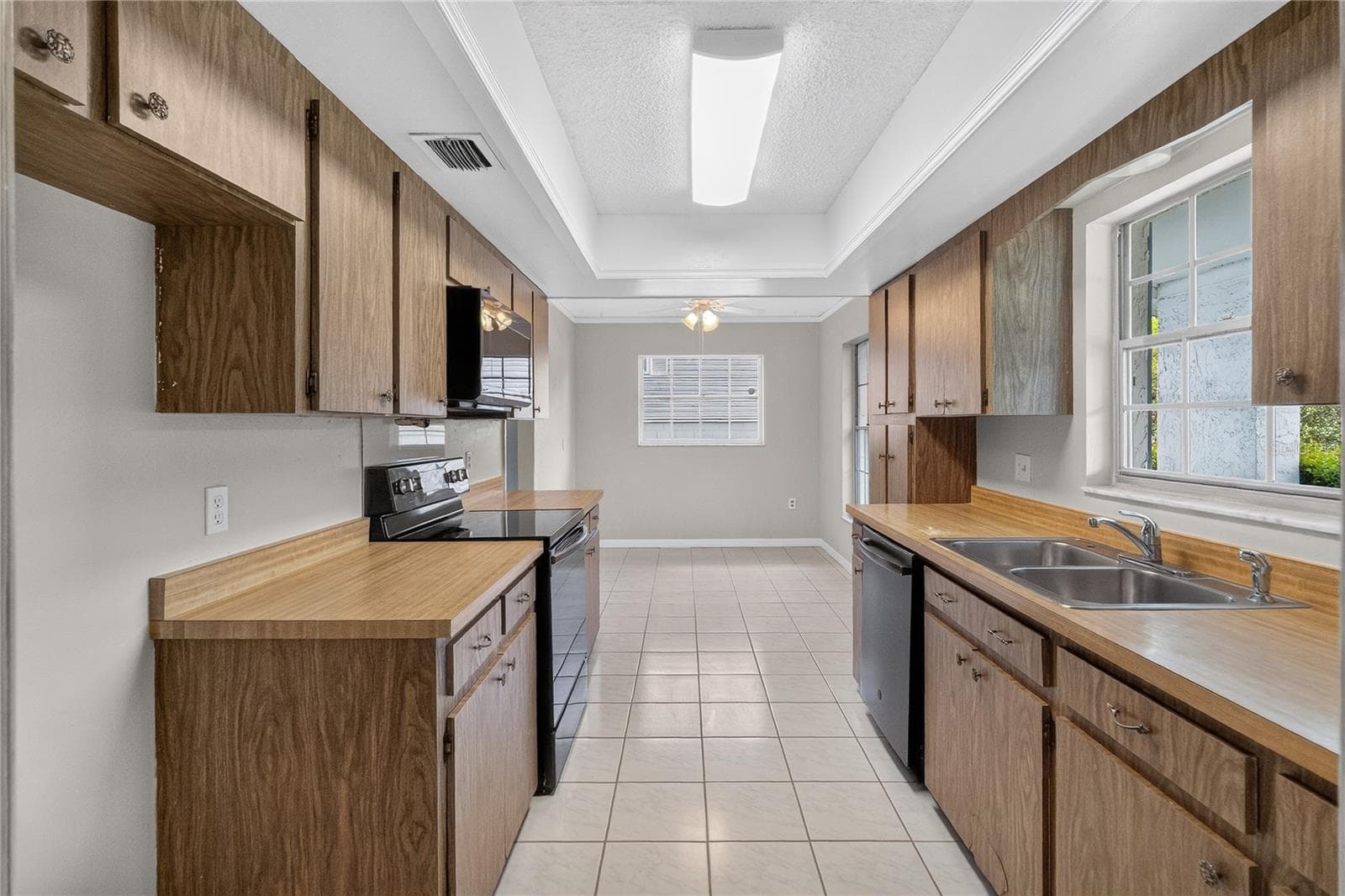 Kitchen is light and bright - having three (3) windows with a window over the kitchen sink. A front-facing kitchen sink window brings in natural light and lets us keep an eye on what’s happening in the front of our home — deliveries, guests arriving, kids playing. - 656 LITTLE WEKIVA RD, ALTAMONTE SPRINGS
