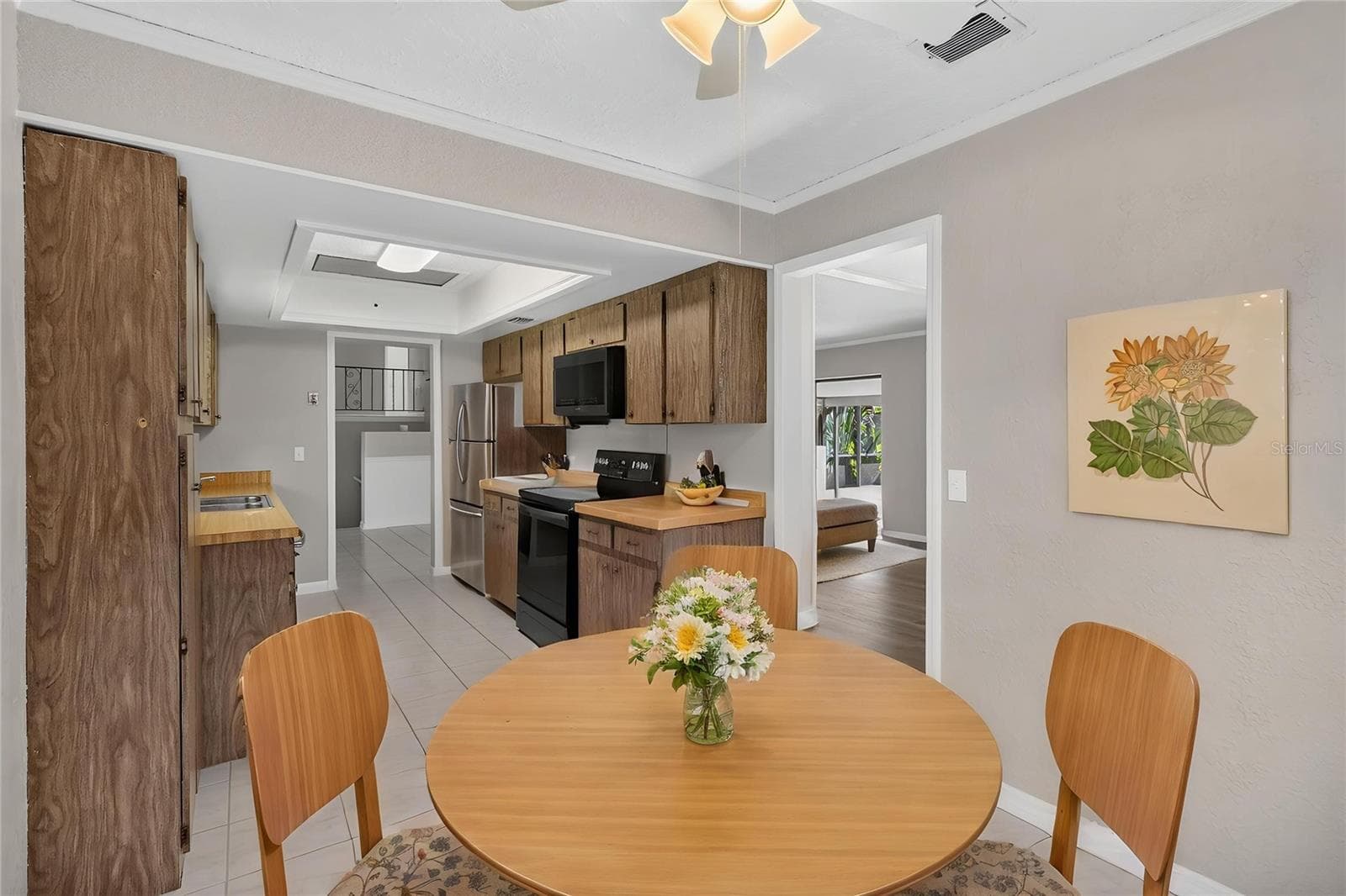 Kitchen from angle of eat-in dinette area. Doorway shown to Dining Room (virtual furnishings) - 656 LITTLE WEKIVA RD, ALTAMONTE SPRINGS