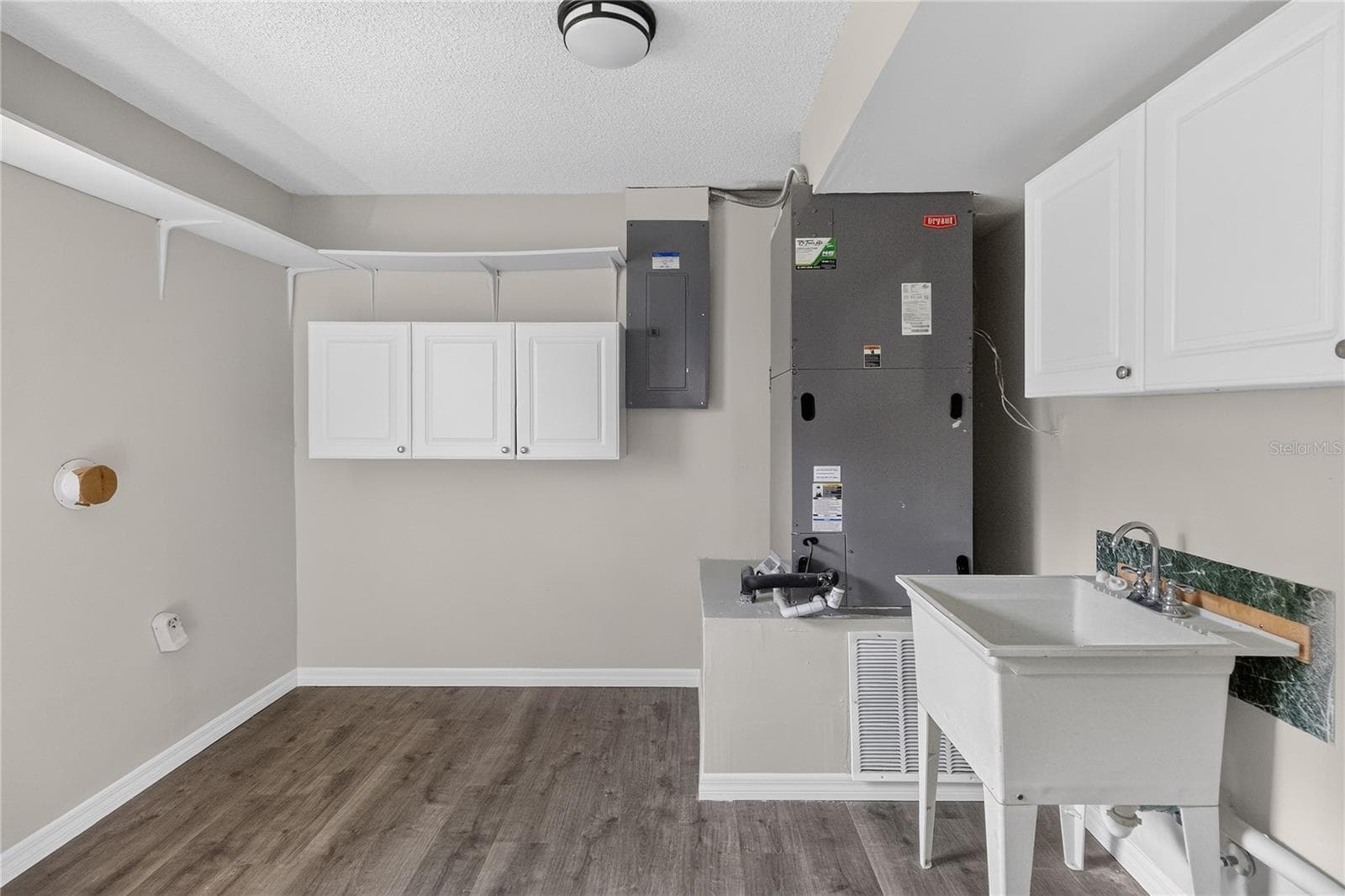 HUGE laundry room with shelving and utility sink. - 656 LITTLE WEKIVA RD, ALTAMONTE SPRINGS