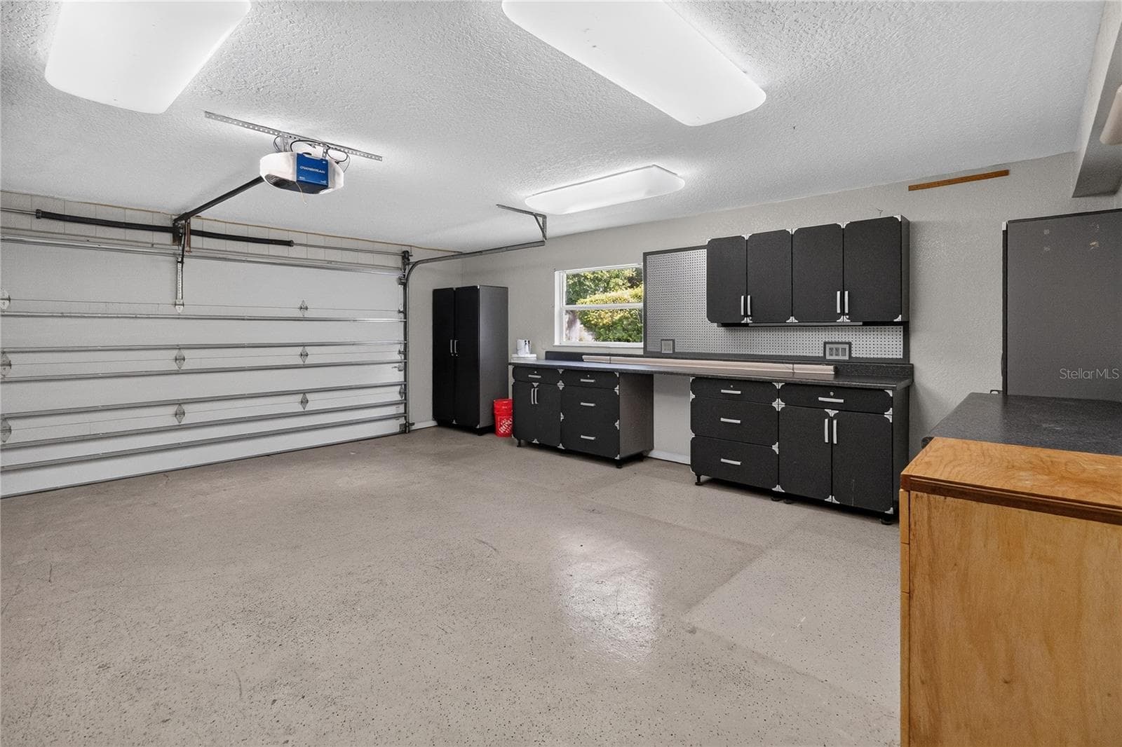 Garage w/ cabinetry, shelving strategically placed electrical outlets throughout w/ WORKSHOP lighting. - 656 LITTLE WEKIVA RD, ALTAMONTE SPRINGS