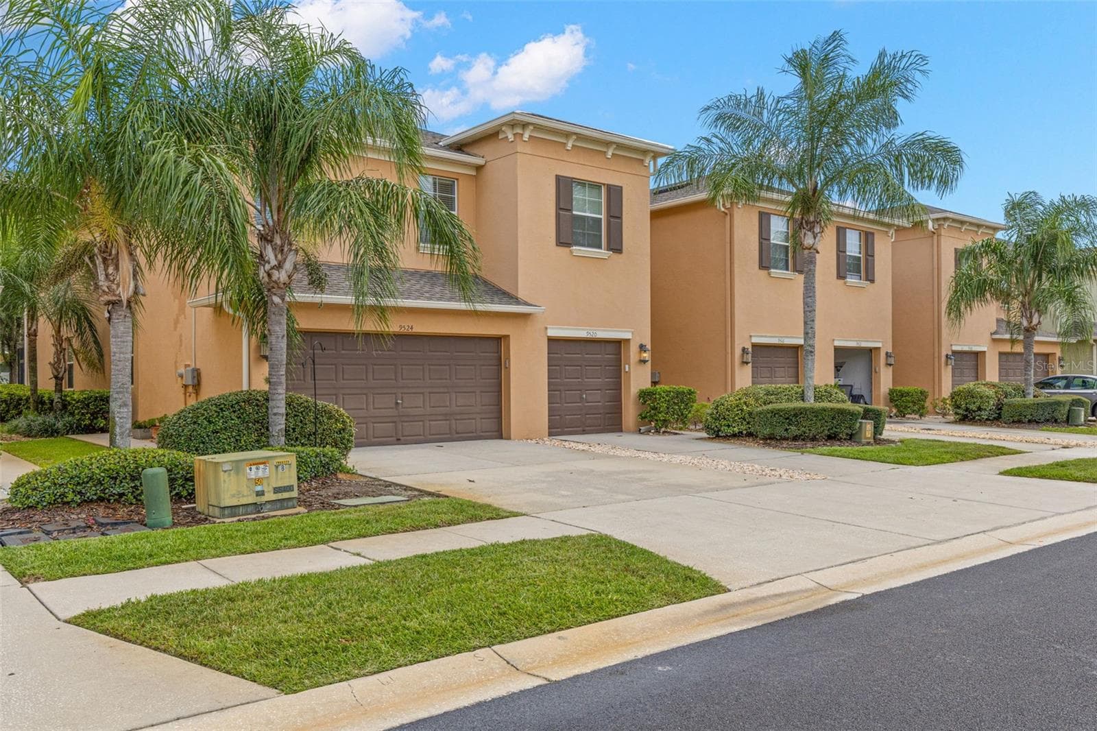 The stucco exterior, architectural rooflines and mature landscaping create a warm Florida look, while the two-car garage adds the space townhome buyers rarely find. - 9524 TRUMPET VINE LOOP, NEW PORT RICHEY