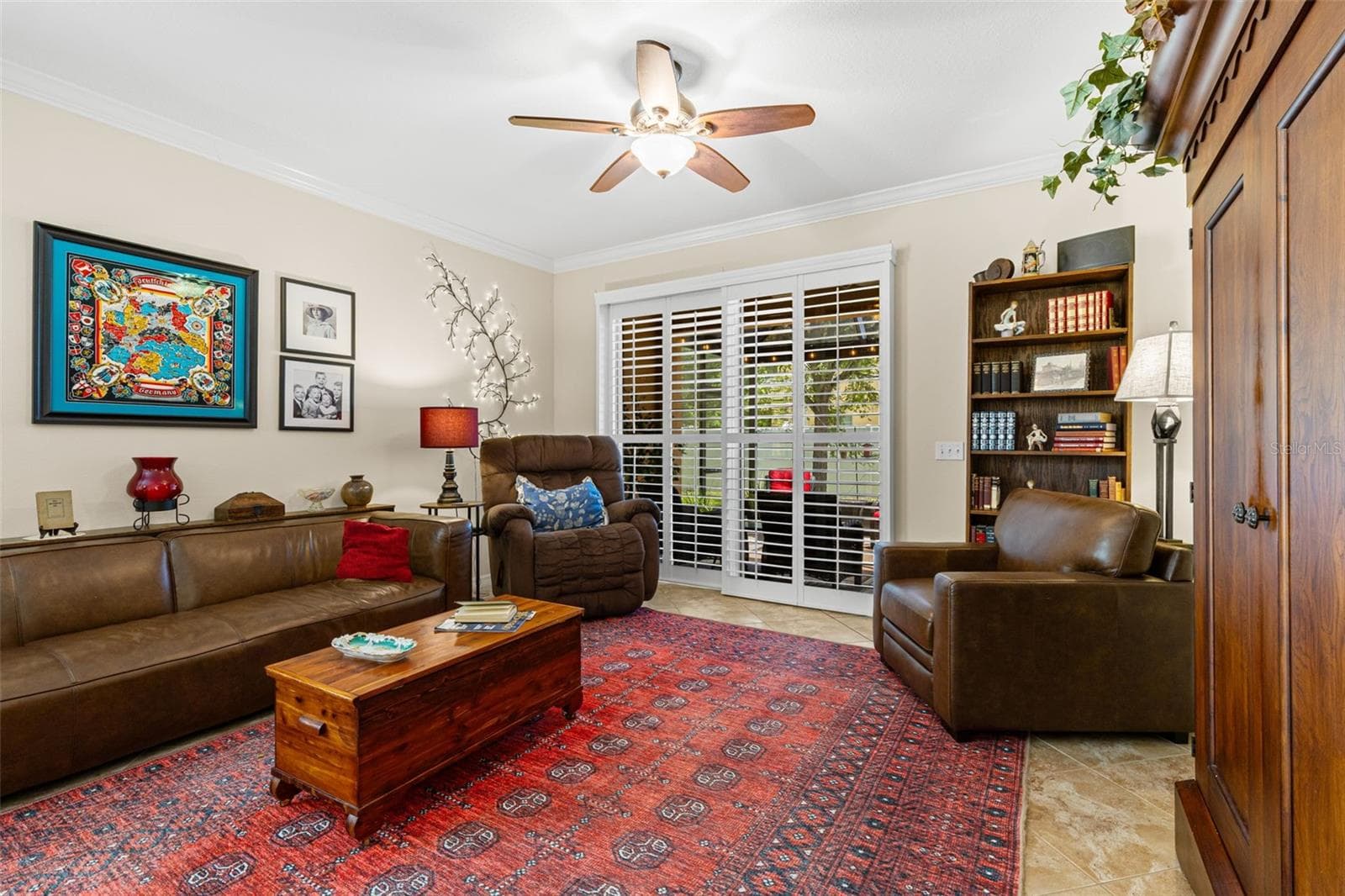 Neutral tones keep the living room easy to personalize, while the ceiling fan adds everyday comfort. - 9524 TRUMPET VINE LOOP, NEW PORT RICHEY