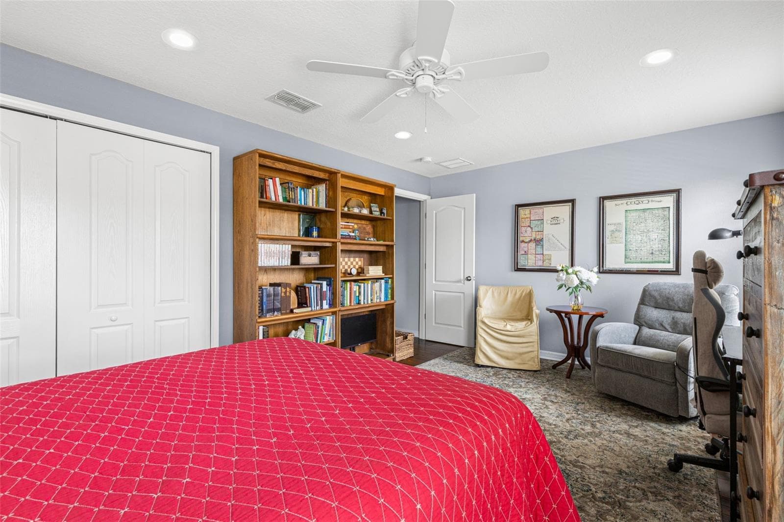 Soft neutral walls, hardwood flooring, a ceiling fan and a built-in closet complete Bedroom 3. - 9524 TRUMPET VINE LOOP, NEW PORT RICHEY