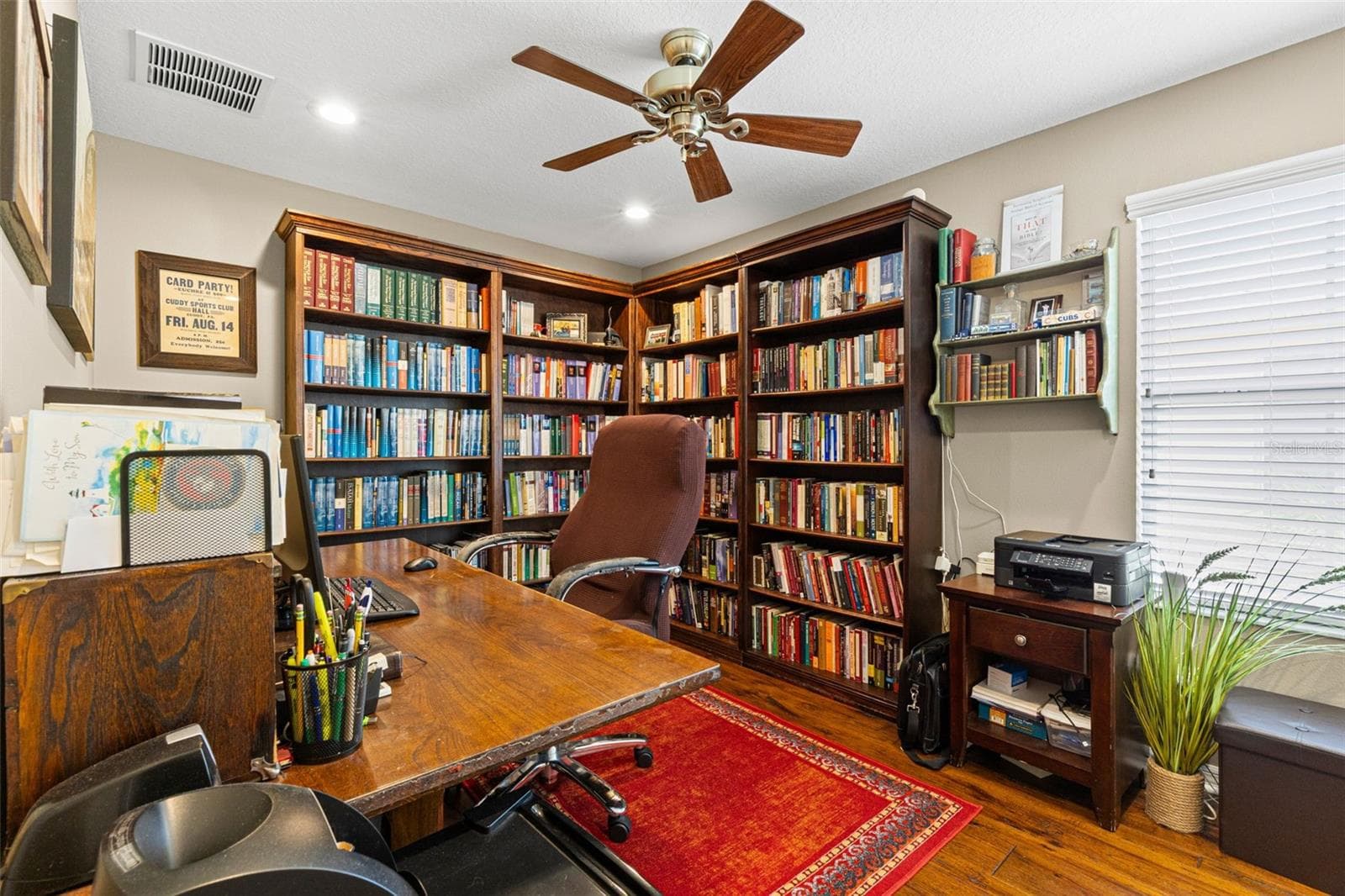 Bedroom 2 is currently used as a home office and library, showing how easily the room can adapt to work, hobbies or guest space. Hardwood flooring, recessed lighting and a ceiling fan complete the room. - 9524 TRUMPET VINE LOOP, NEW PORT RICHEY
