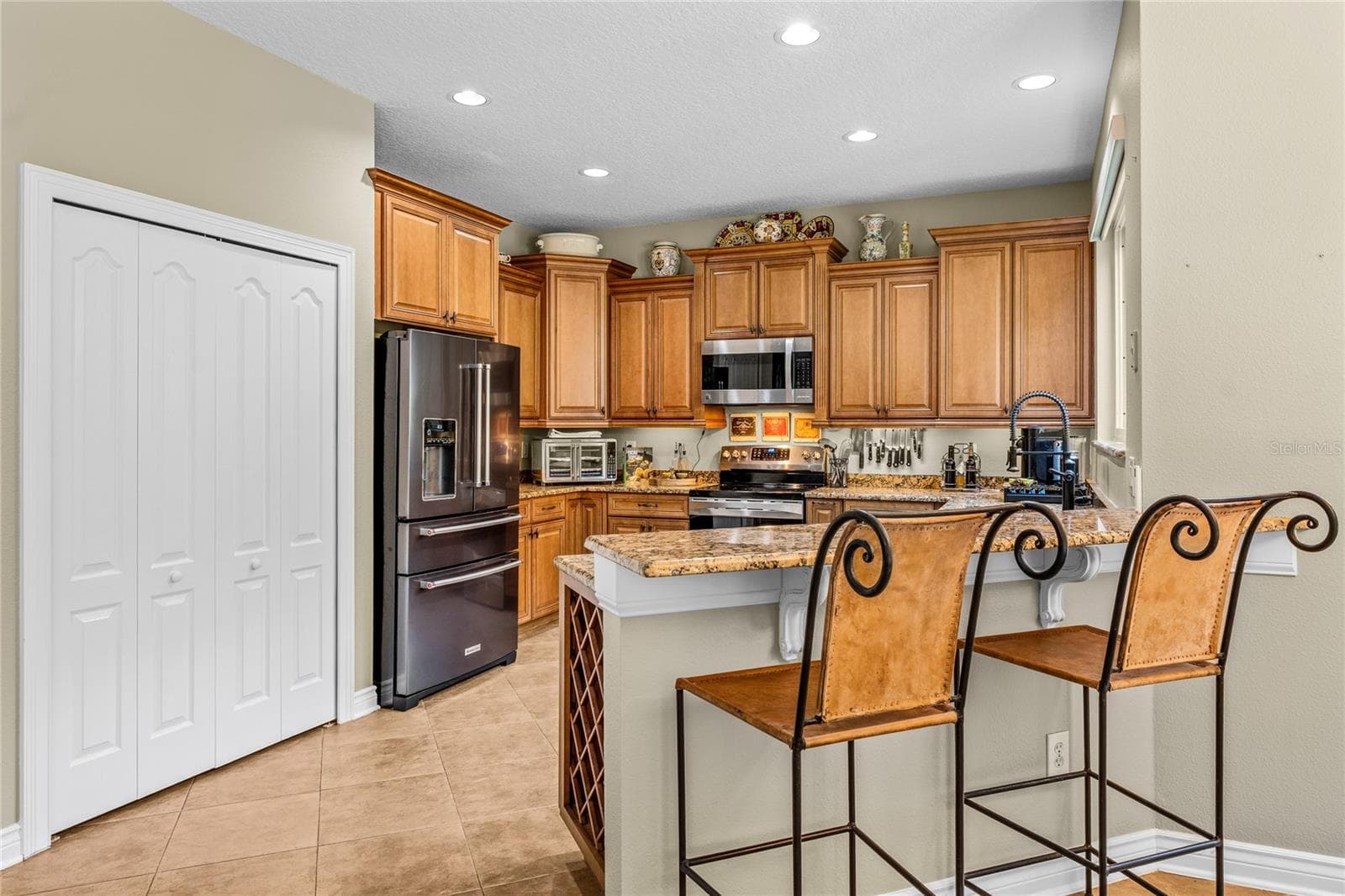 The kitchen has high line appliance package with a serving bar. - 483 VIA TUSCANY LOOP, LAKE MARY