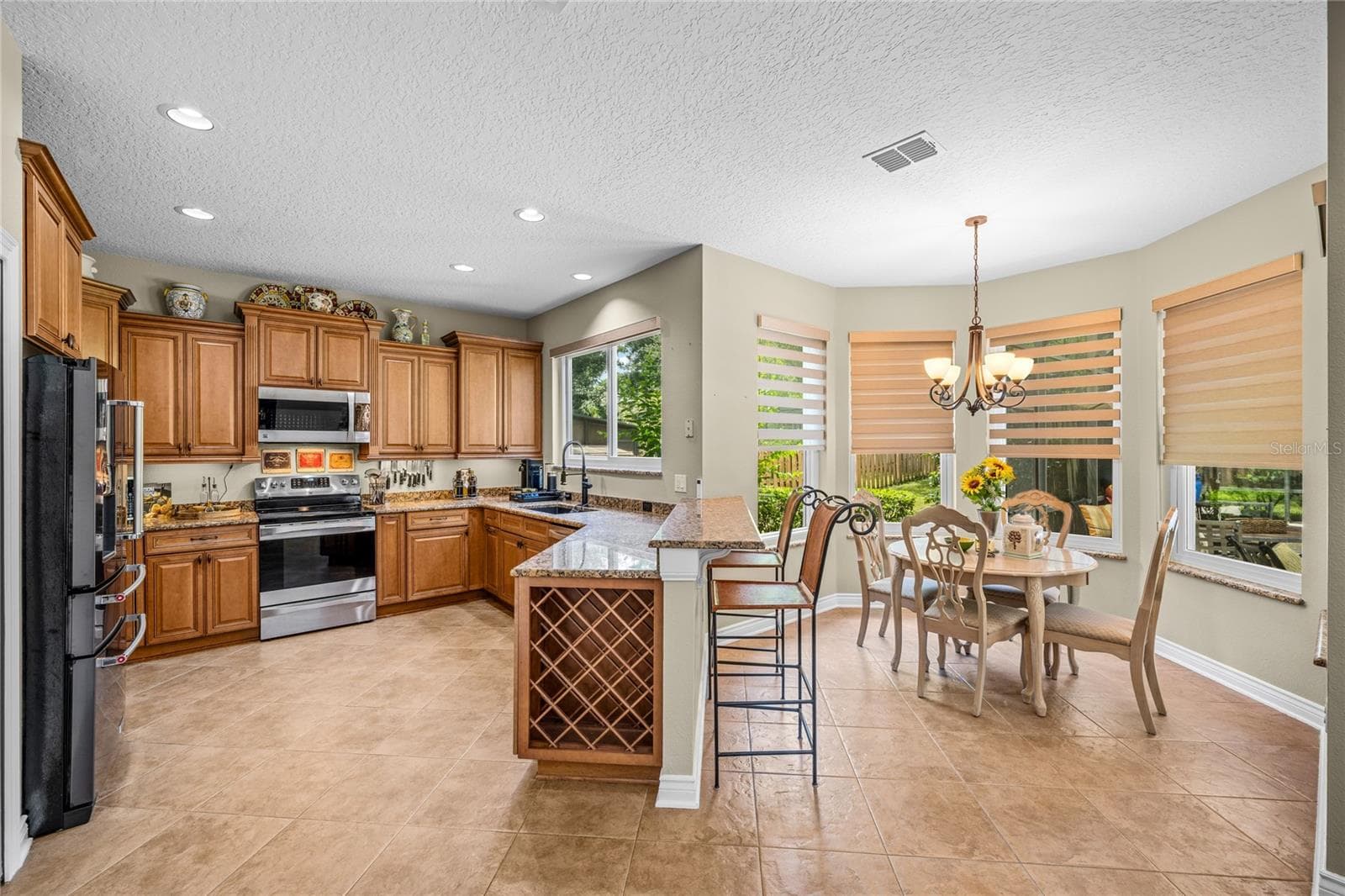 The kitchen has a wine rack and an abundance of cabinetry - 483 VIA TUSCANY LOOP, LAKE MARY