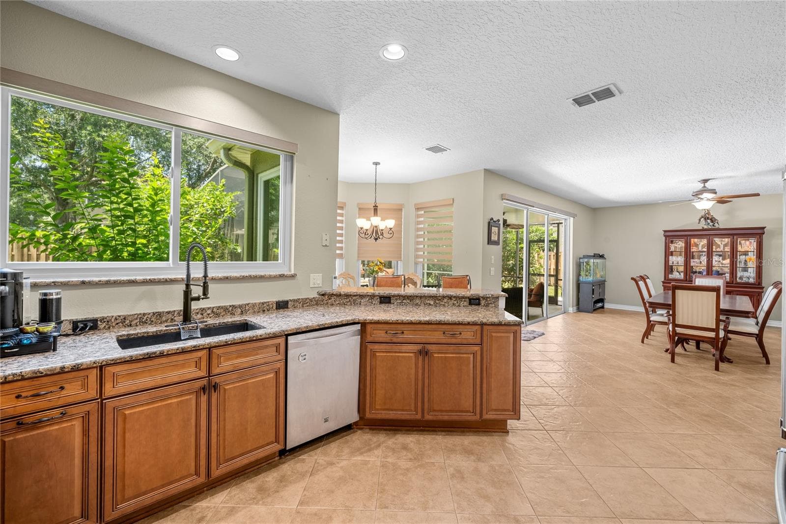 The kitchen is open to the poolside area with brand new windows. - 483 VIA TUSCANY LOOP, LAKE MARY