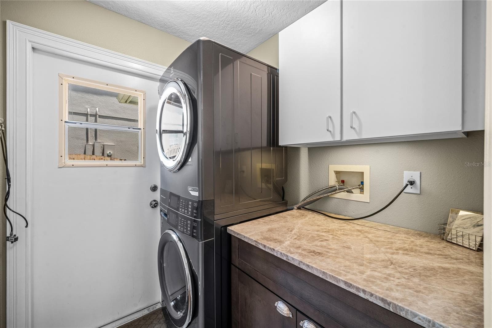 The laundry area, has built in cabinets hanging on the wall - 483 VIA TUSCANY LOOP, LAKE MARY