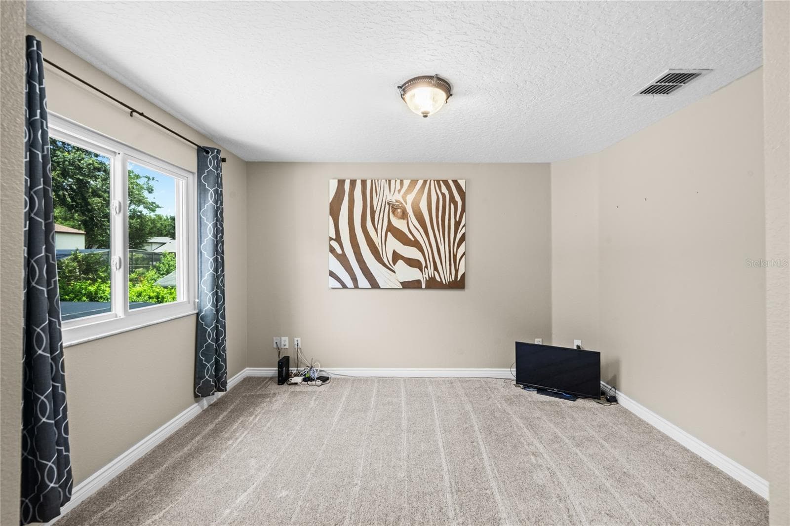 Fourth bedroom with plush carpet over looking the back yard. - 483 VIA TUSCANY LOOP, LAKE MARY
