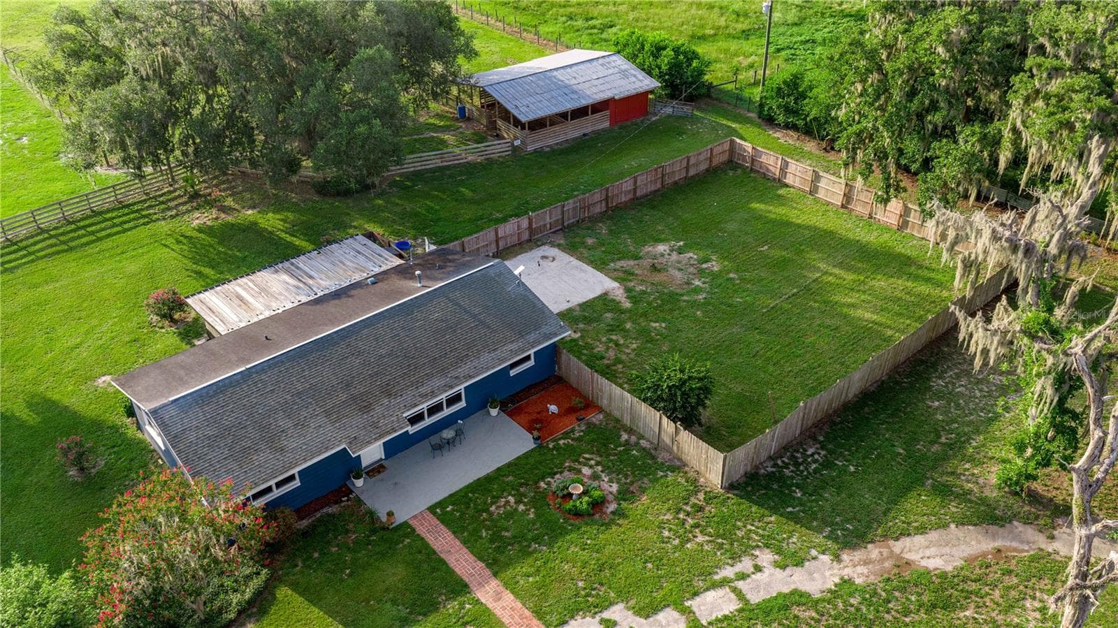 Overview of the home, fenced-in side yard, and the barn area. - 15027 SW 91ST ST, ARCHER