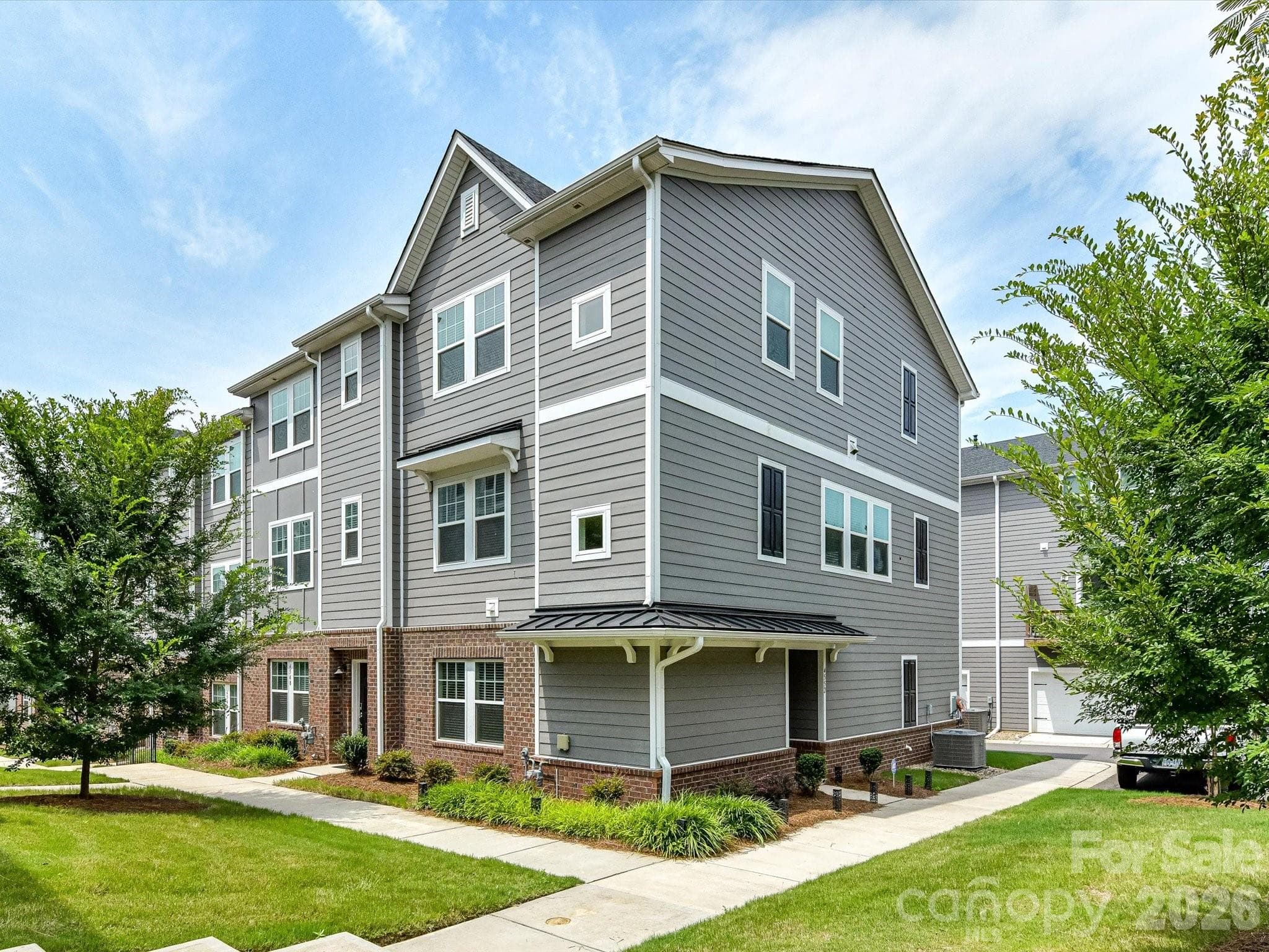 Beautifully designed 4-bedroom, 3.5-bath Charlotte townhome with contemporary finishes, a private balcony, versatile flex space, and easy access to Uptown, South End, and the Charlotte Regional Farmers Market. - 4552 Millennium Avenue, Charlotte