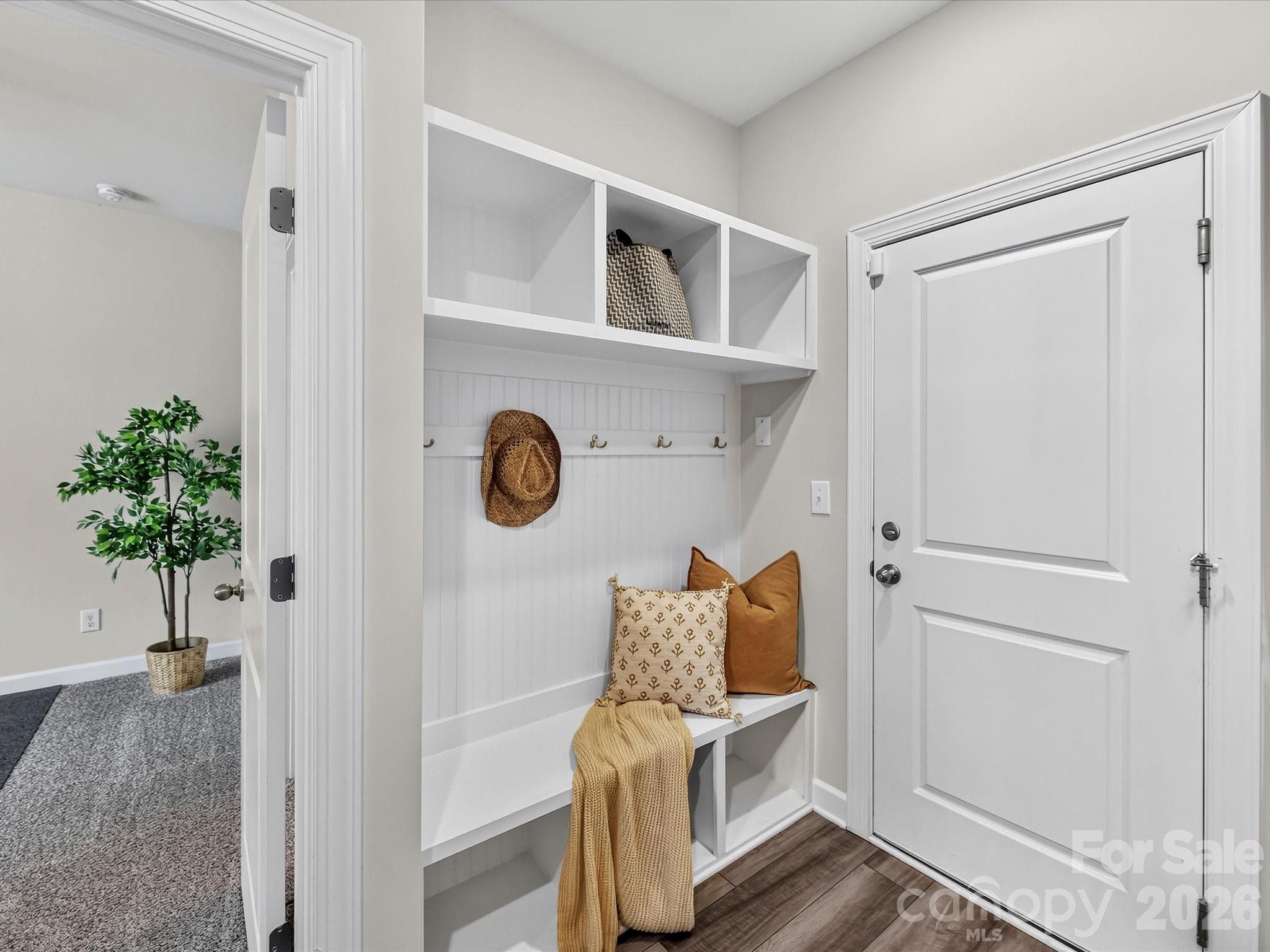 Built-in drop zone with bench seating, storage cubbies, and coat hooks adds everyday organization and convenience. - 4552 Millennium Avenue, Charlotte