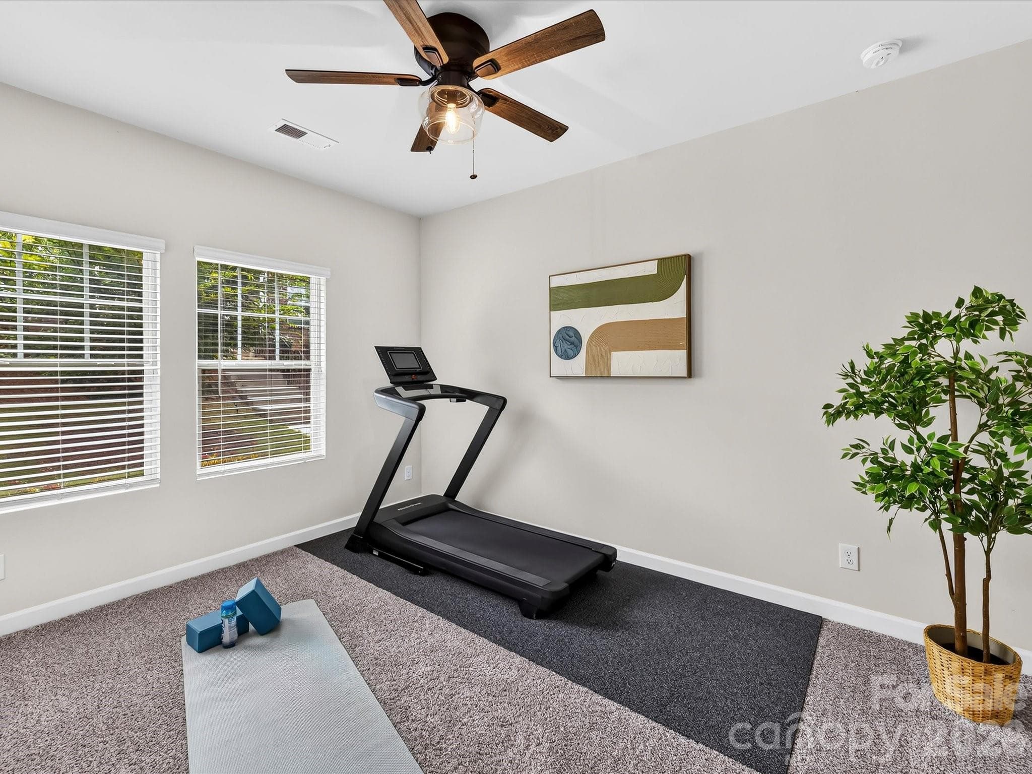 Versatile main-level bedroom with private en-suite bath is perfect for guests, a home office, or multi-generational living. - 4552 Millennium Avenue, Charlotte