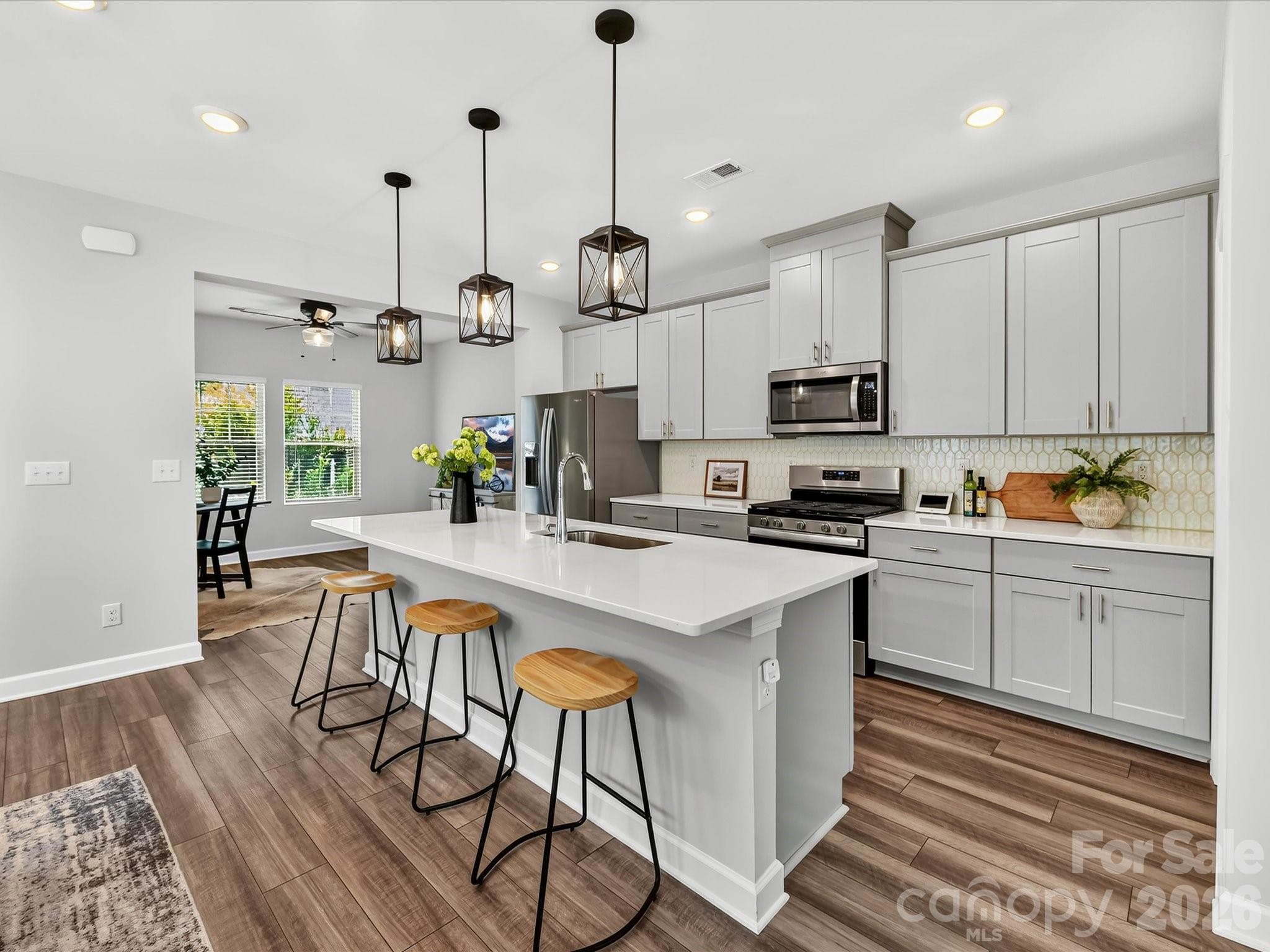 Open-concept kitchen offers timeless finishes, generous prep space, and seamless flow for entertaining. - 4552 Millennium Avenue, Charlotte