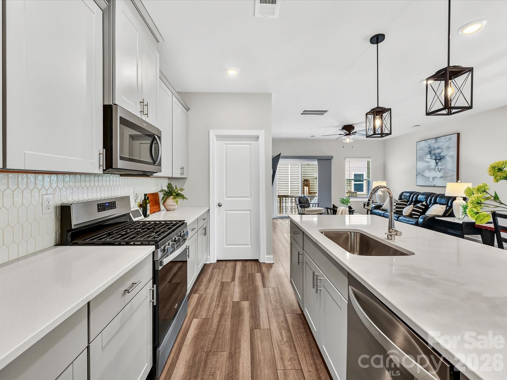 Open-concept kitchen offers timeless finishes, generous prep space, and seamless flow for entertaining. - 4552 Millennium Avenue, Charlotte