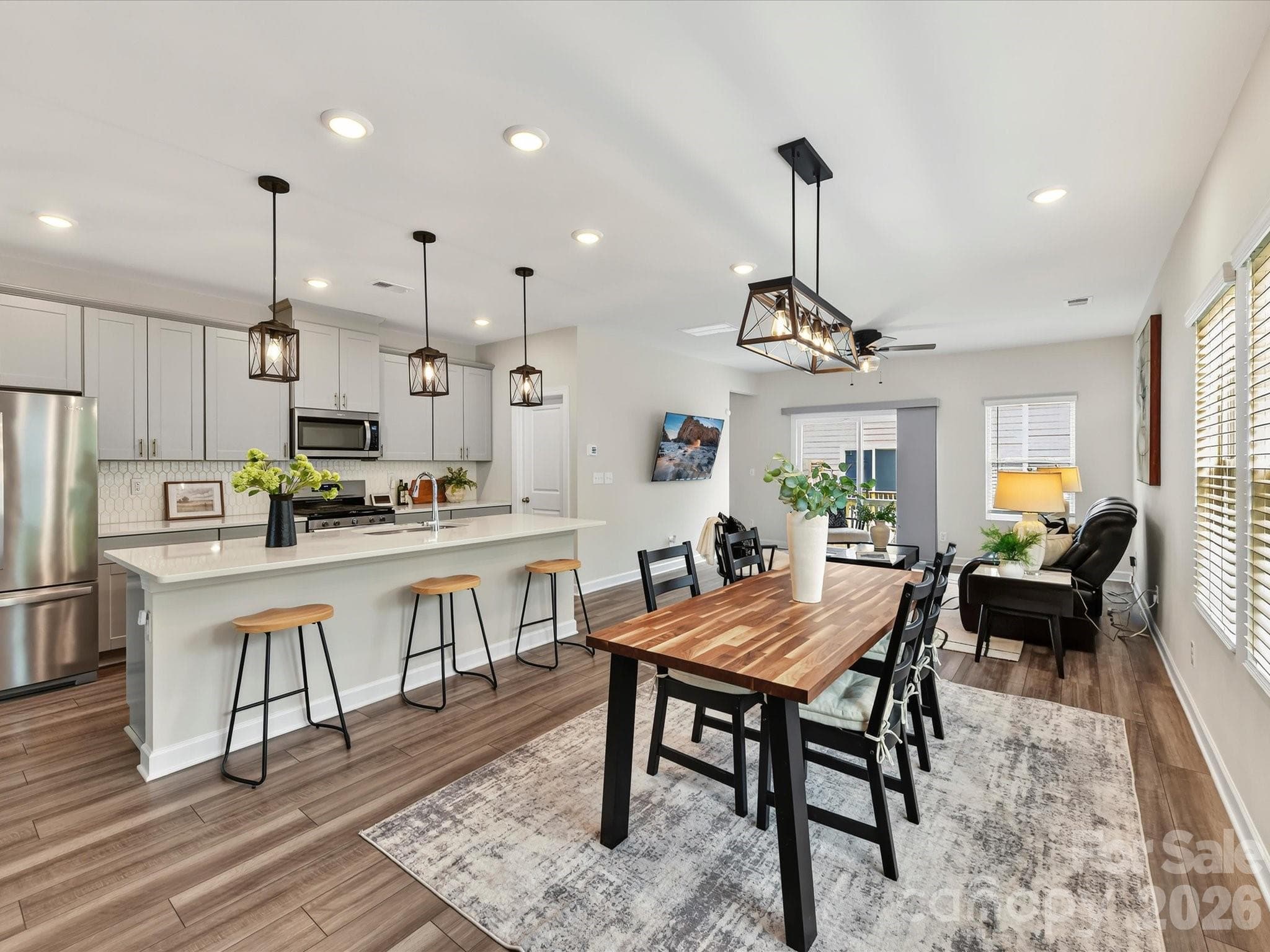 The spacious kitchen and dining area blend beautifully together, creating the perfect gathering space for family and friends. - 4552 Millennium Avenue, Charlotte