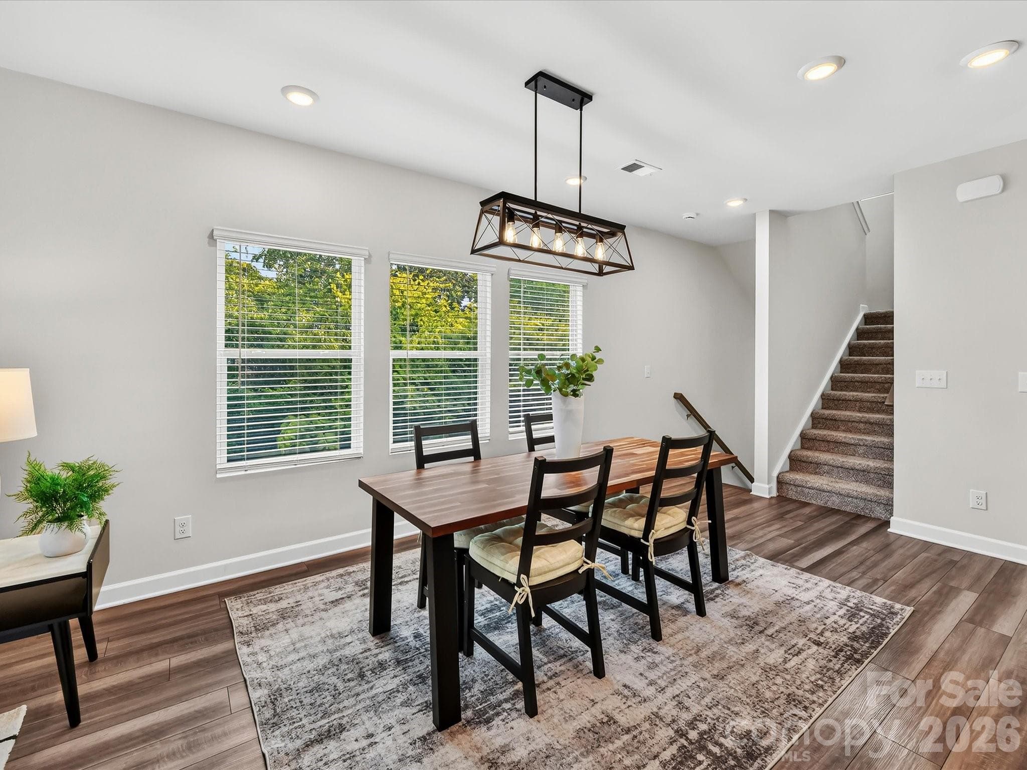 Light-filled dining area overlooks peaceful wooded views and provides an ideal setting for everyday meals or special occasions. - 4552 Millennium Avenue, Charlotte