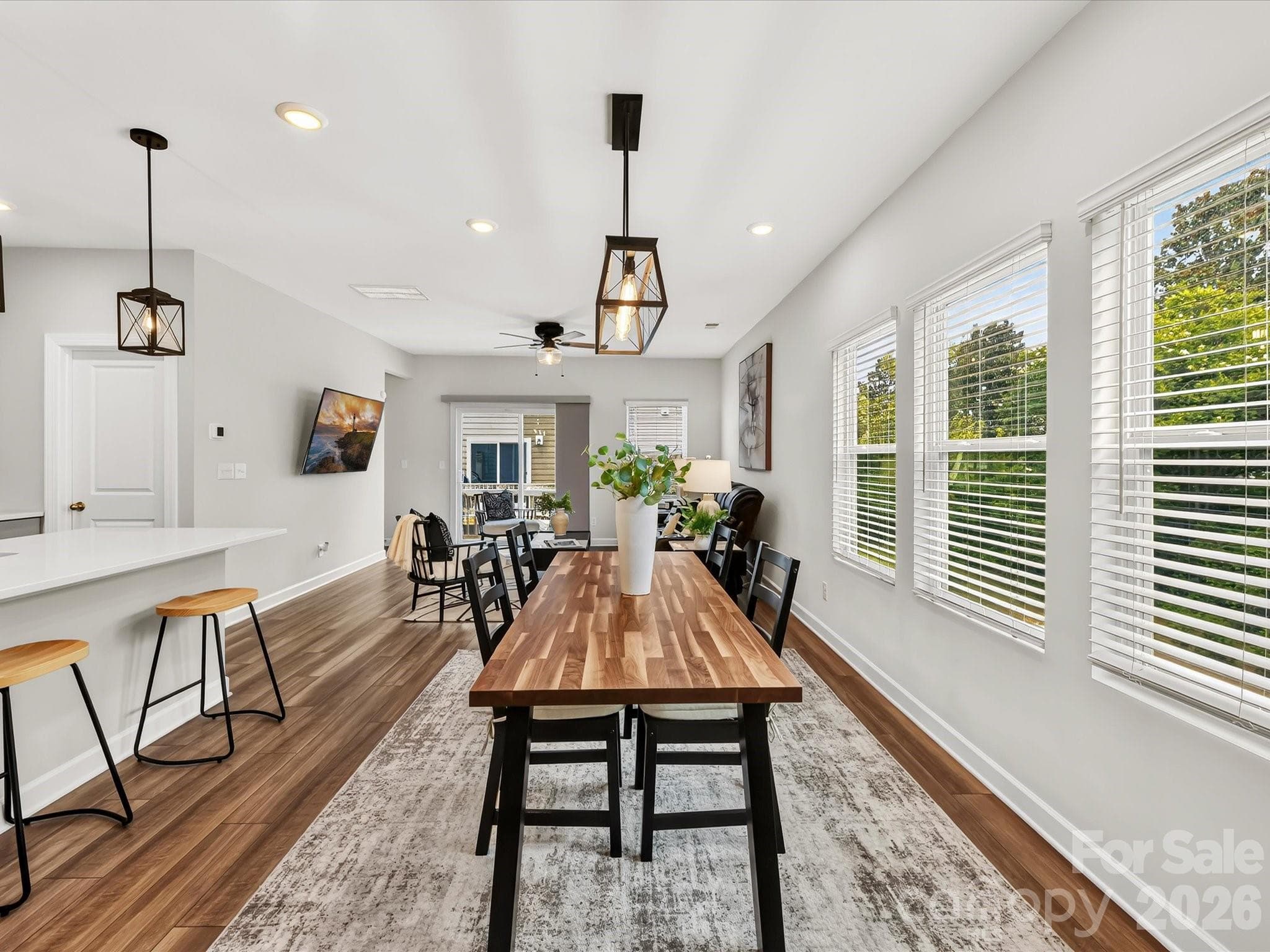 Light-filled dining area overlooks peaceful wooded views and provides an ideal setting for everyday meals or special occasions. - 4552 Millennium Avenue, Charlotte