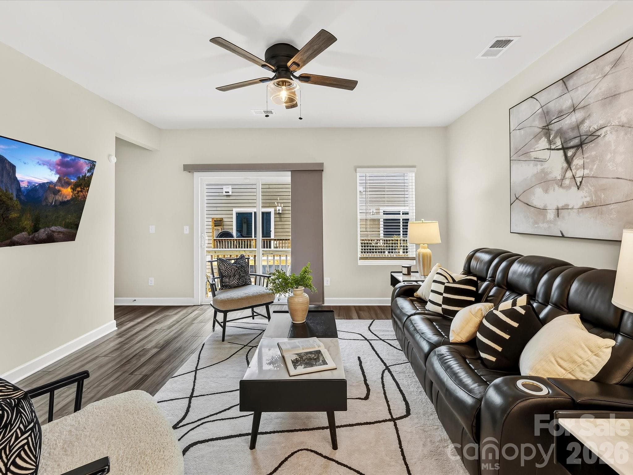Spacious family room offers the perfect place to relax or entertain, complete with oversized windows, modern finishes, and an open-concept design. - 4552 Millennium Avenue, Charlotte