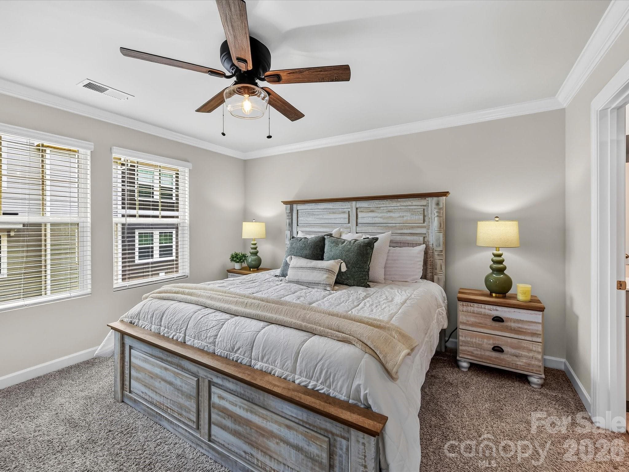 Spacious primary suite offers a peaceful retreat with abundant natural light and elegant finishes. - 4552 Millennium Avenue, Charlotte