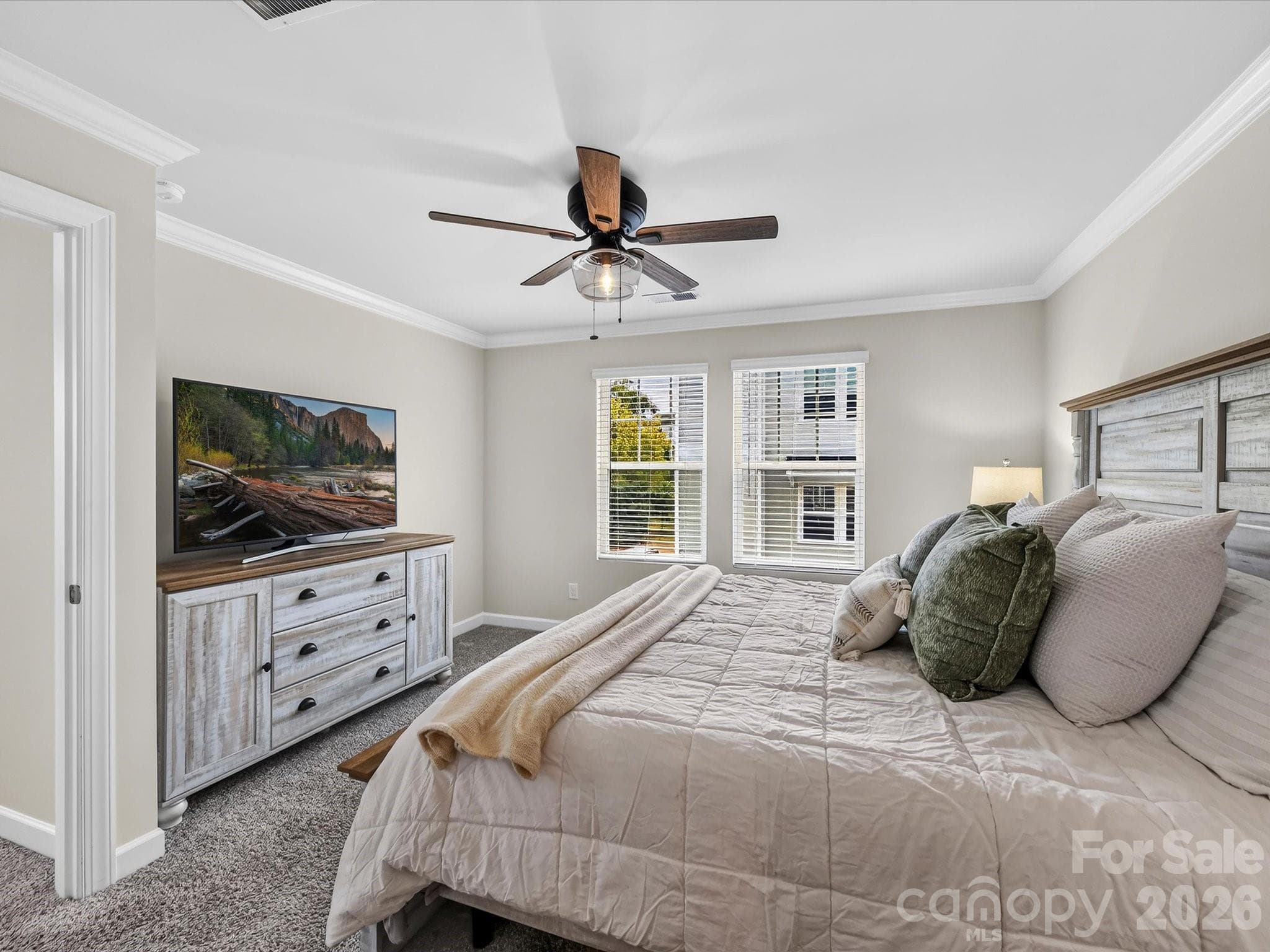 Spacious primary suite offers a peaceful retreat with abundant natural light and elegant finishes. - 4552 Millennium Avenue, Charlotte