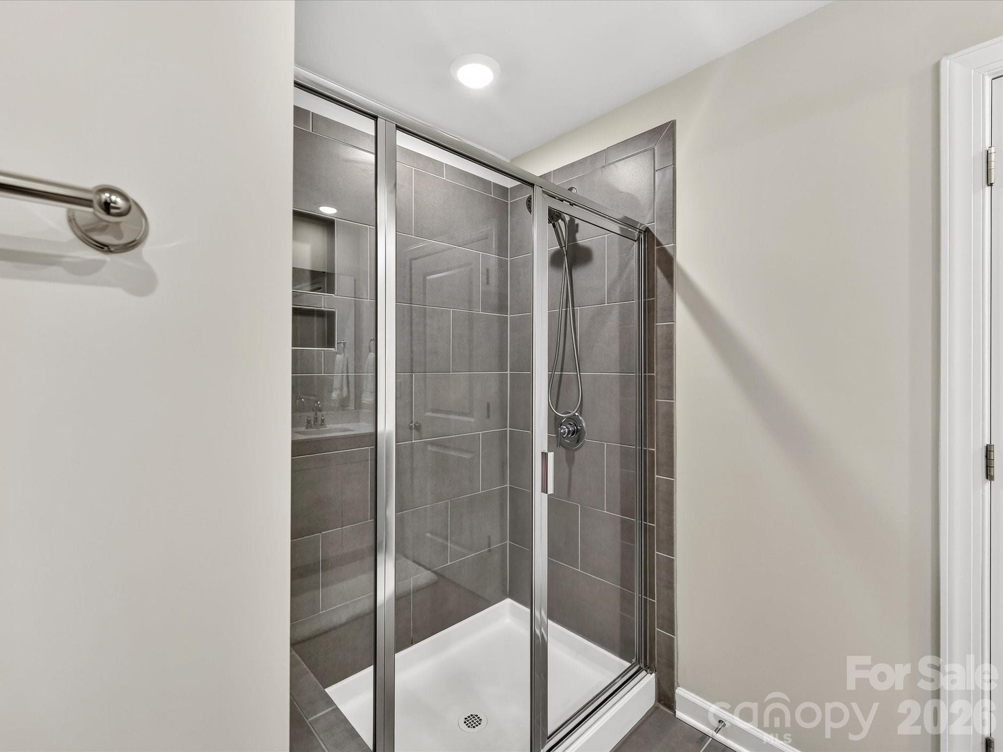 Spa-inspired primary bathroom features dual vanities, a spacious walk-in shower, and ample storage. - 4552 Millennium Avenue, Charlotte