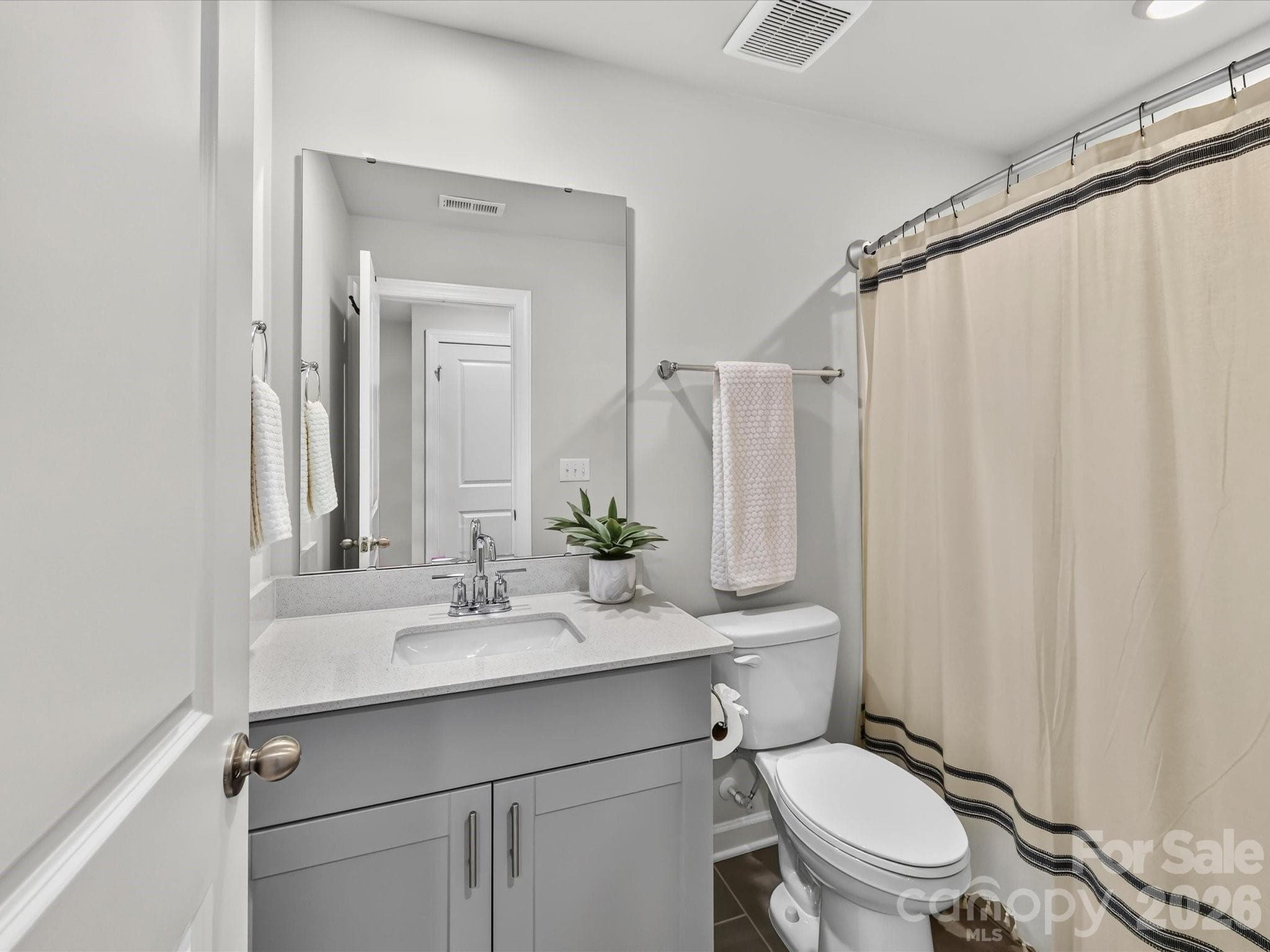 Well-appointed full bathroom features a modern vanity and tub/shower combination. - 4552 Millennium Avenue, Charlotte