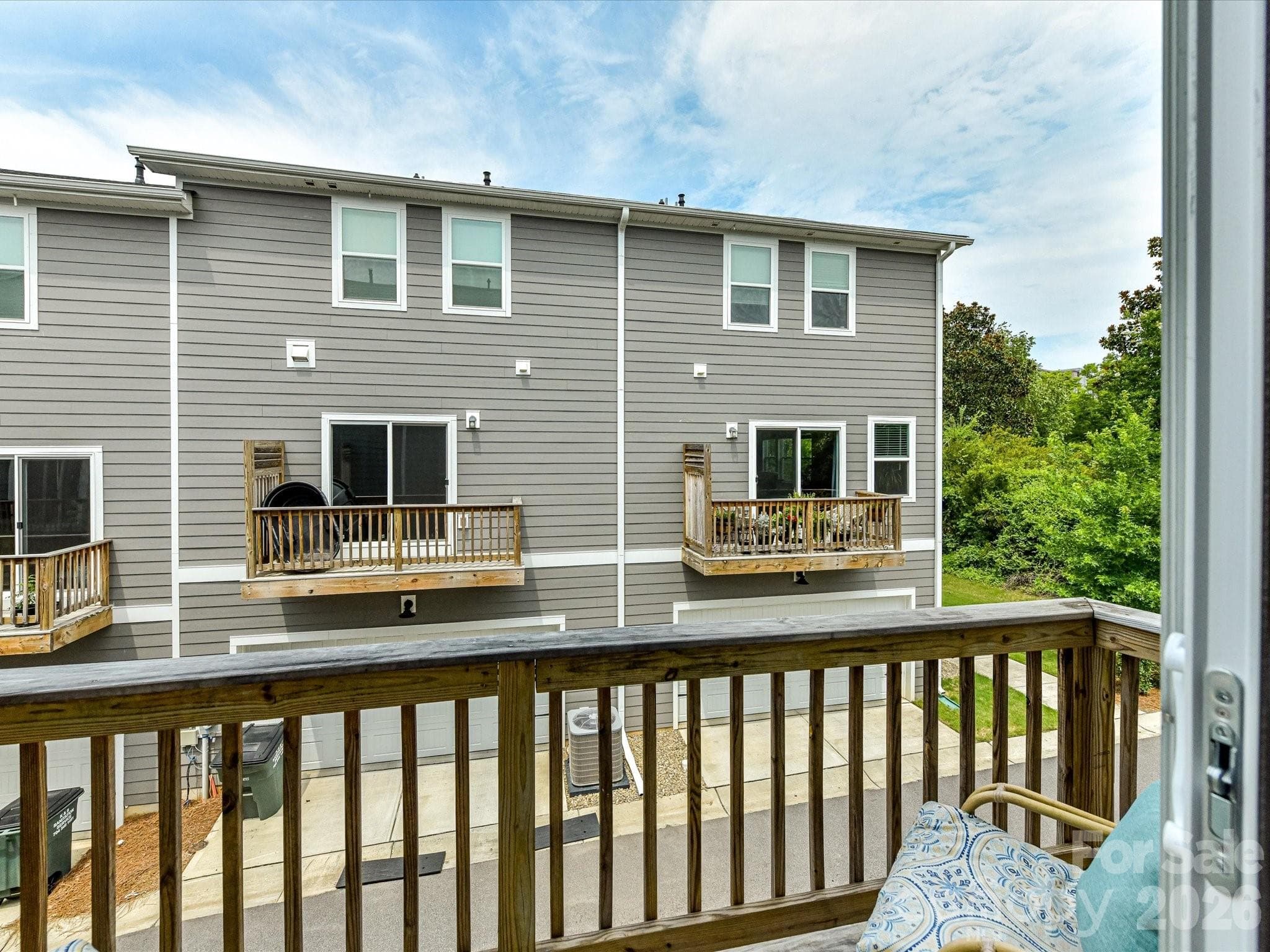 Private covered balcony provides the perfect spot to enjoy your morning coffee or unwind while overlooking the neighborhood. - 4552 Millennium Avenue, Charlotte