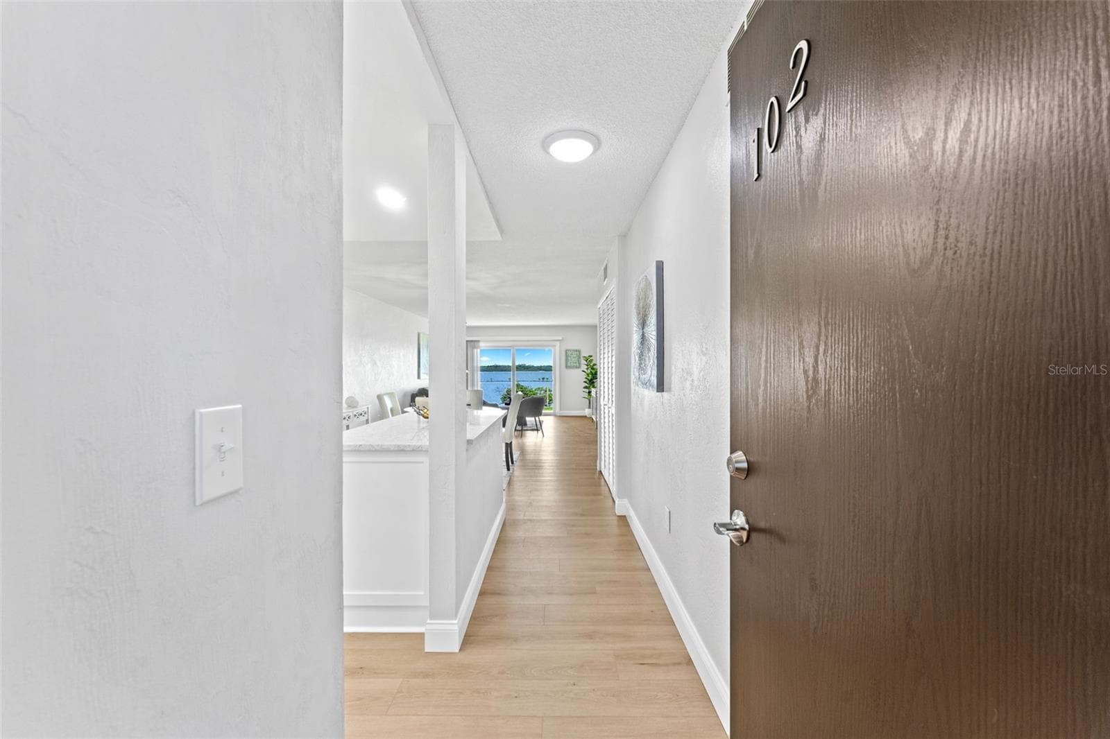 Welcome to unit #102.  Side, lobby and even back patio entry. - 3606 S PENINSULA DR #102, PORT ORANGE