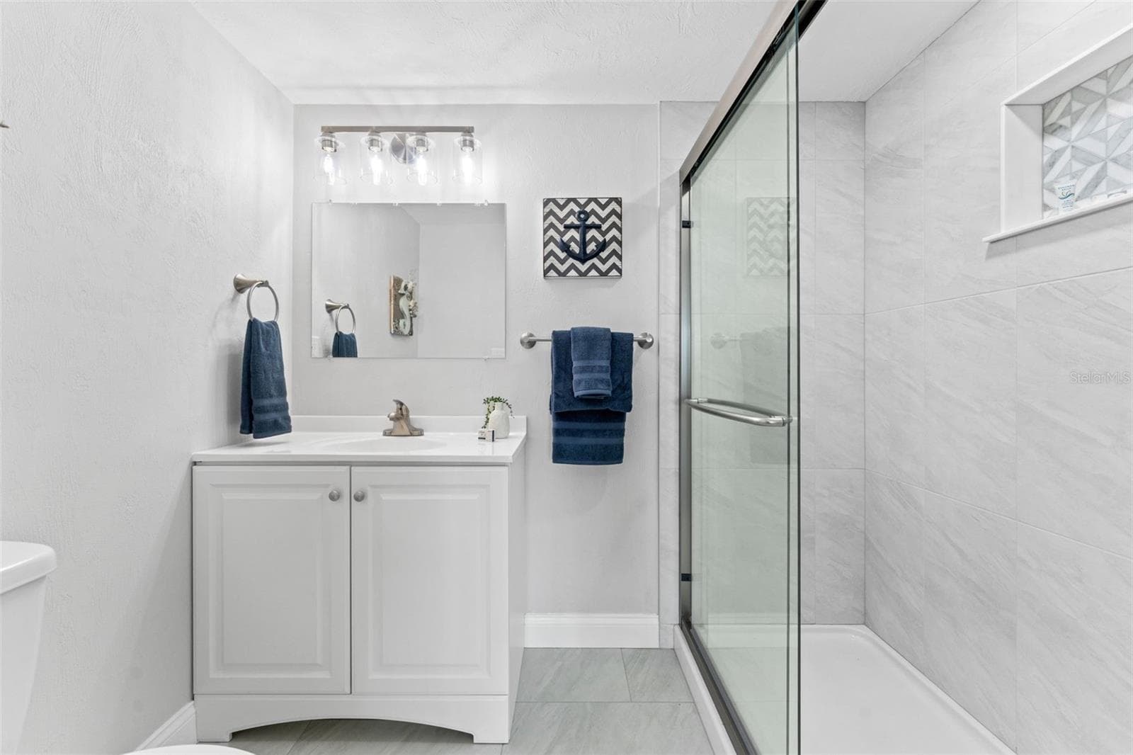 Bathroom with walk-in shower. - 3606 S PENINSULA DR #102, PORT ORANGE