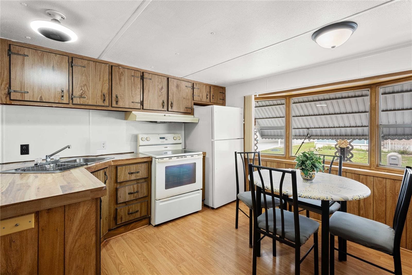 Kitchen is open with living room. - 5318 ASTRID DR, ZEPHYRHILLS